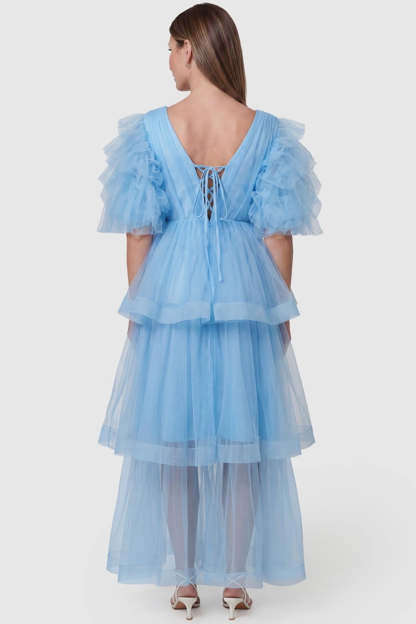 Tiered Ruffled Tulle Flutter Sleeve Maternity Maxi Gown Tiered Ruffled Tulle Flutter Sleeve Maternity Maxi Gown in Blue featuring lace-up back detail on pregnant model, back view.