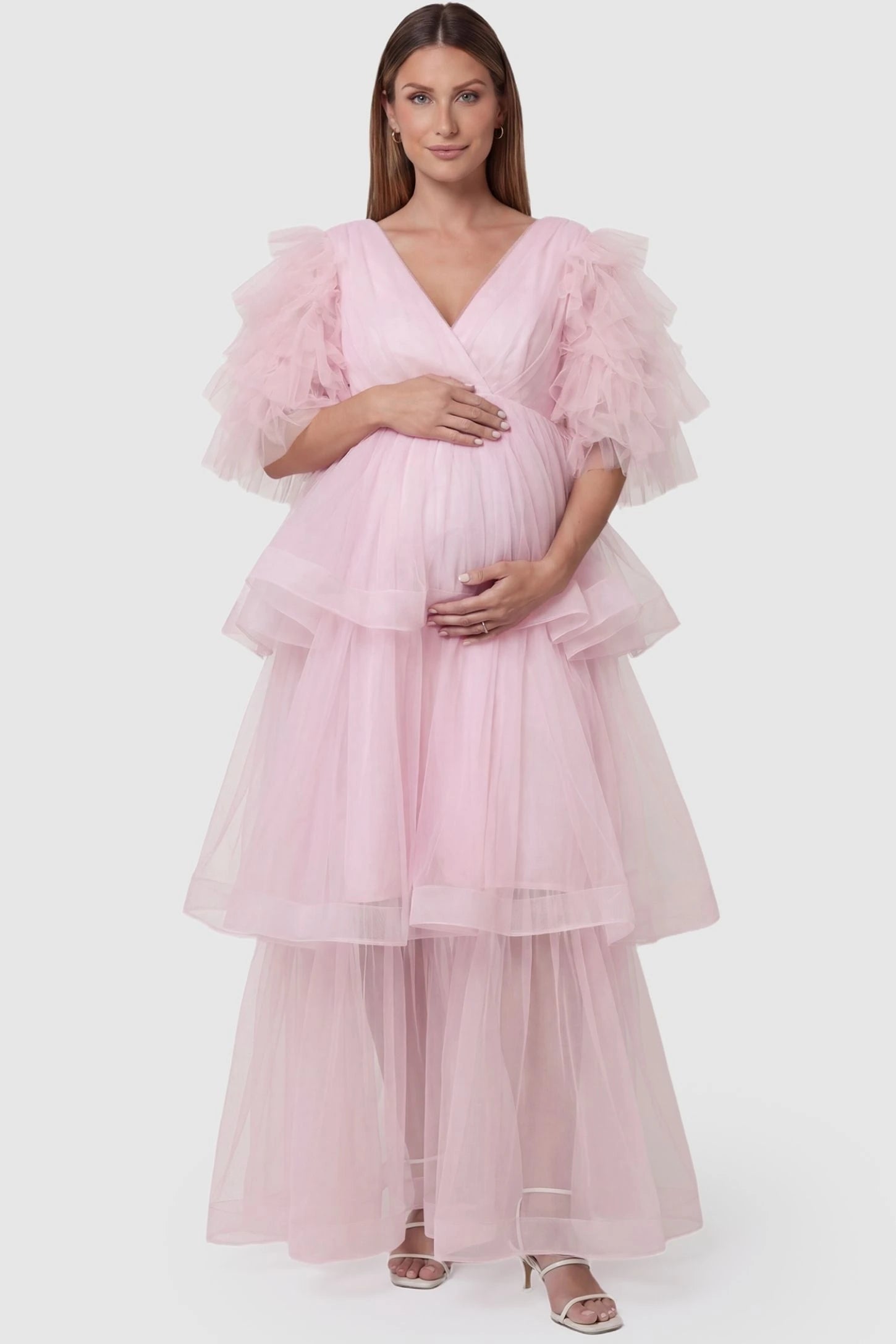 Tiered Ruffled Tulle Flutter Sleeve Maternity Maxi Gown Tiered Ruffled Tulle Flutter Sleeve Maternity Maxi Gown in Pink featuring layered tulle skirt on pregnant model, front view.
