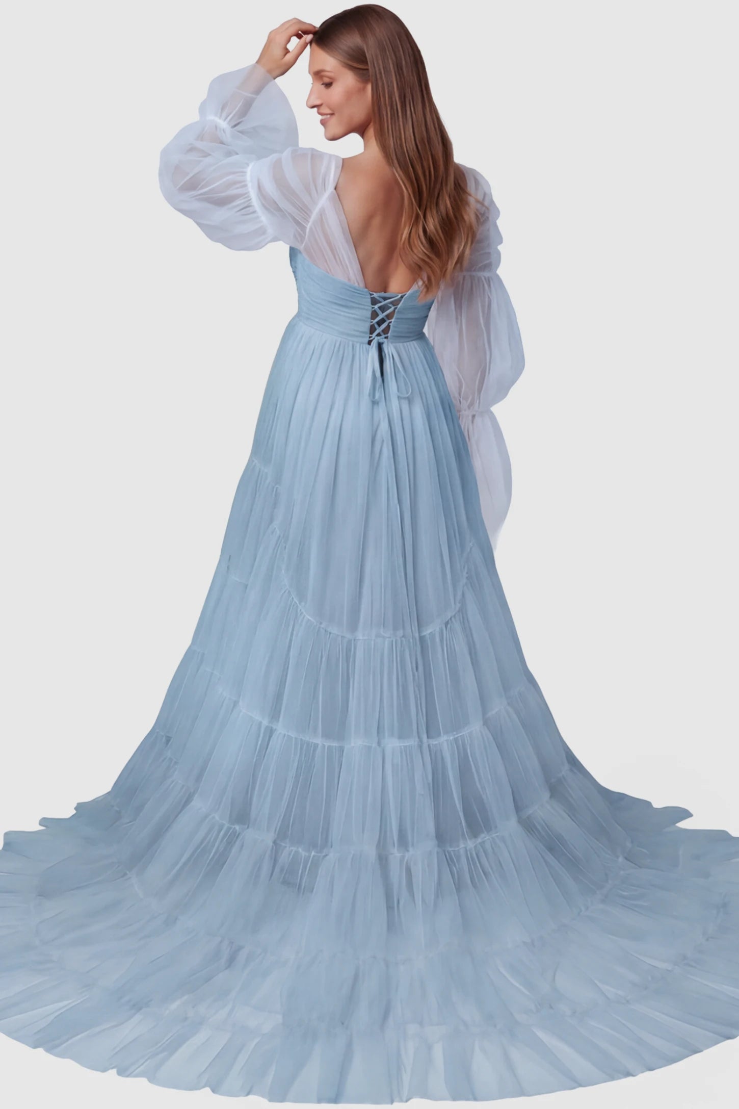 Tiered Tulle Long Sleeve Maternity Photoshoot Gown Tiered Tulle Long Sleeve Maternity photoshoot Gown in Blue featuring a lace-up corset back and floor-length skirt on a model, back view.