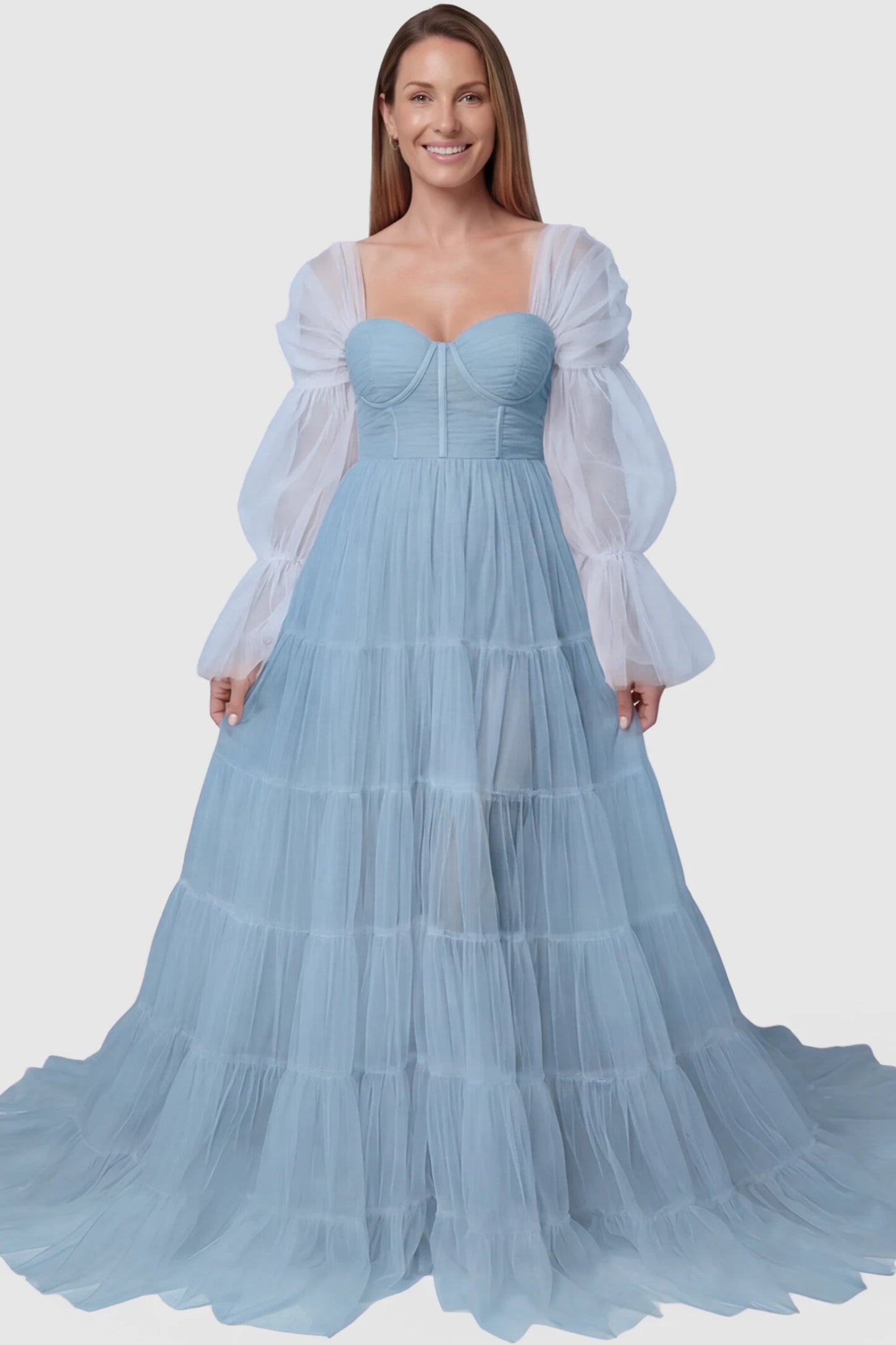 Tiered Tulle Long Sleeve Maternity Photoshoot Gown Tiered Tulle Long Sleeve Maternity photoshoot Gown in Blue featuring a sweetheart neckline and voluminous tulle layers on a postpartum model, front view.