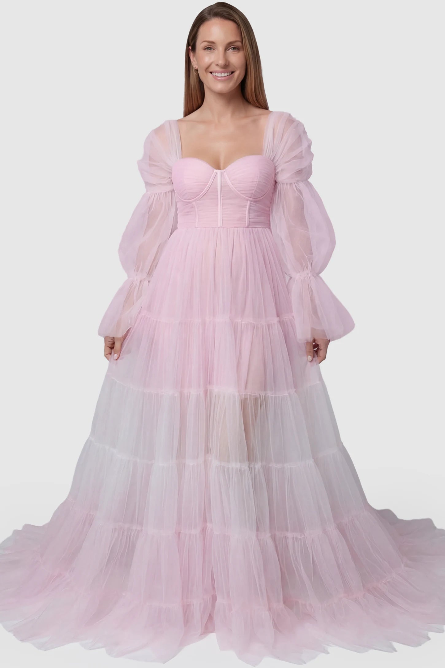 Tiered Tulle Long Sleeve Maternity Photoshoot Gown Tiered Tulle Long Sleeve Maternity photoshoot Gown in Pink featuring a sweetheart neckline and voluminous tulle layers on a postpartum model, front view.