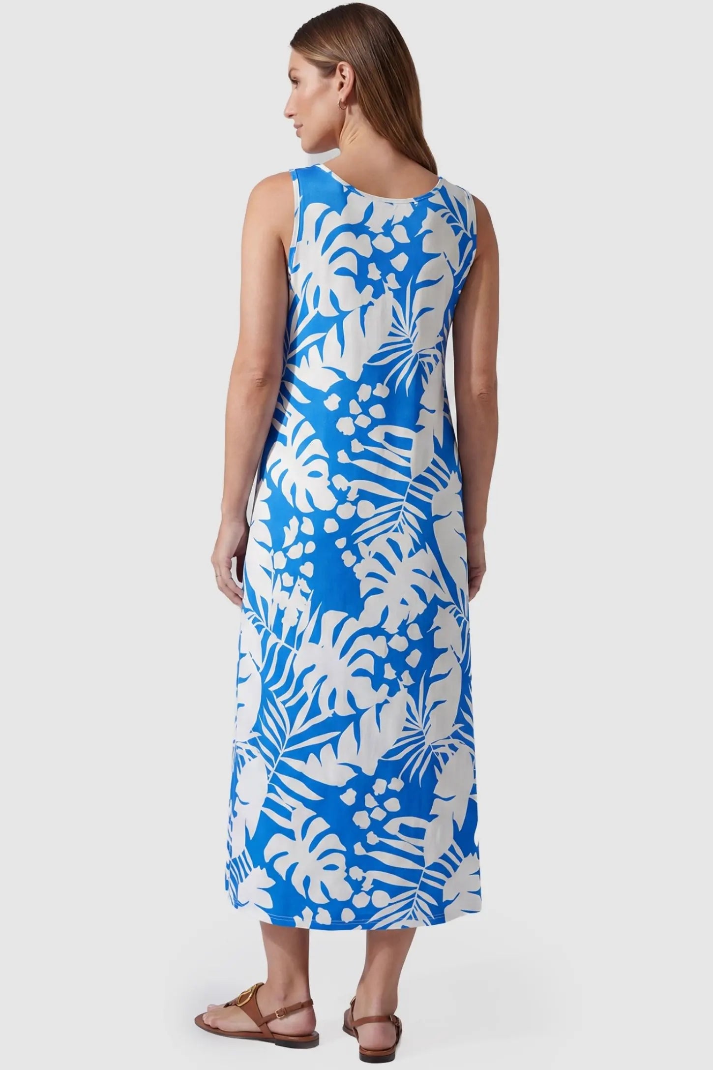 Tropical Print Sleeveless Midi Maternity Dress Tropical Print Sleeveless Midi Maternity Dress in Blue featuring a deep palm print design on a pregnant model, back view.