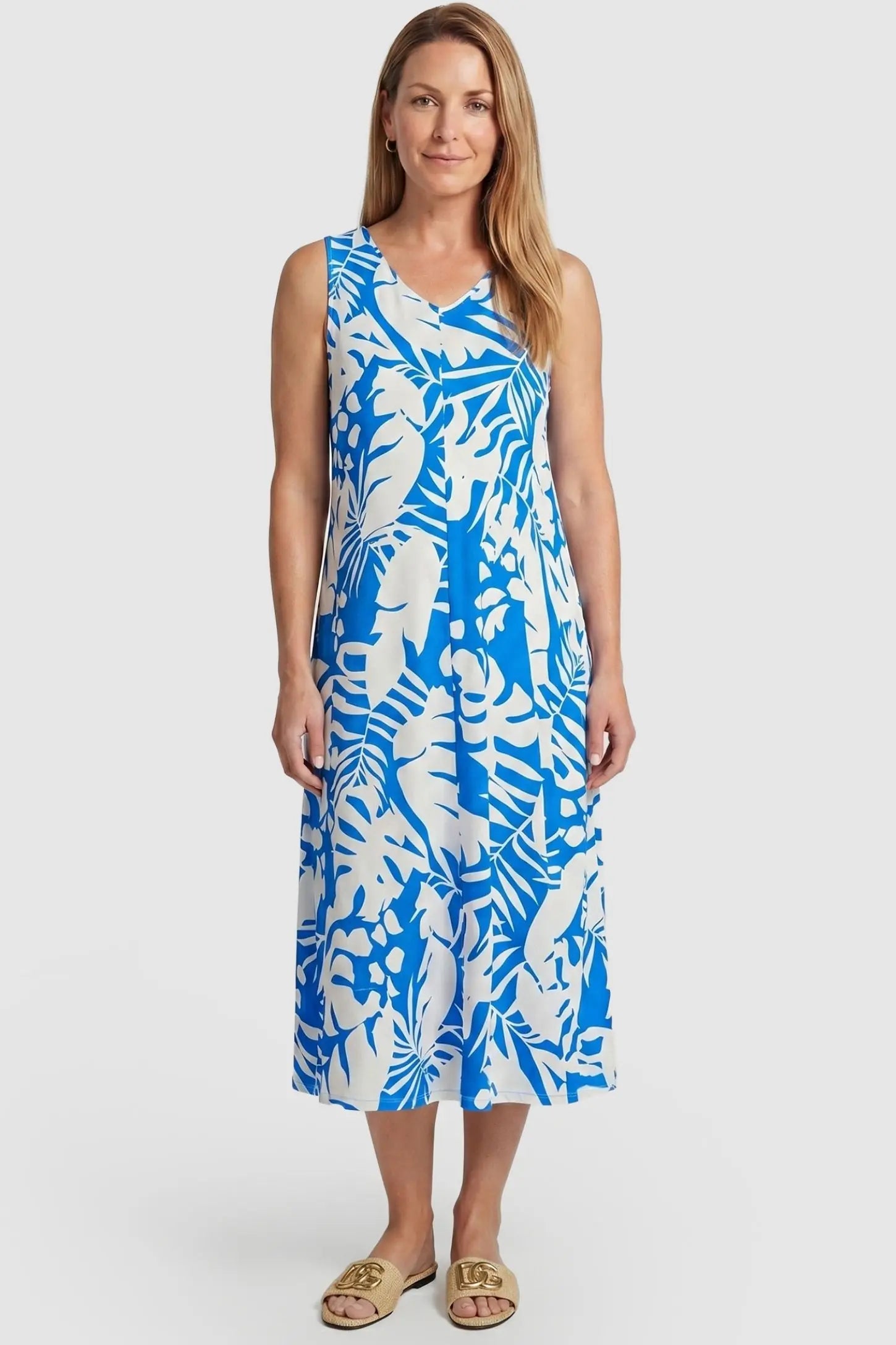 Tropical Print Sleeveless Midi Maternity Dress Tropical Print Sleeveless Midi Maternity Dress in Blue featuring a flowy midi silhouette on a postpartum model, front view.