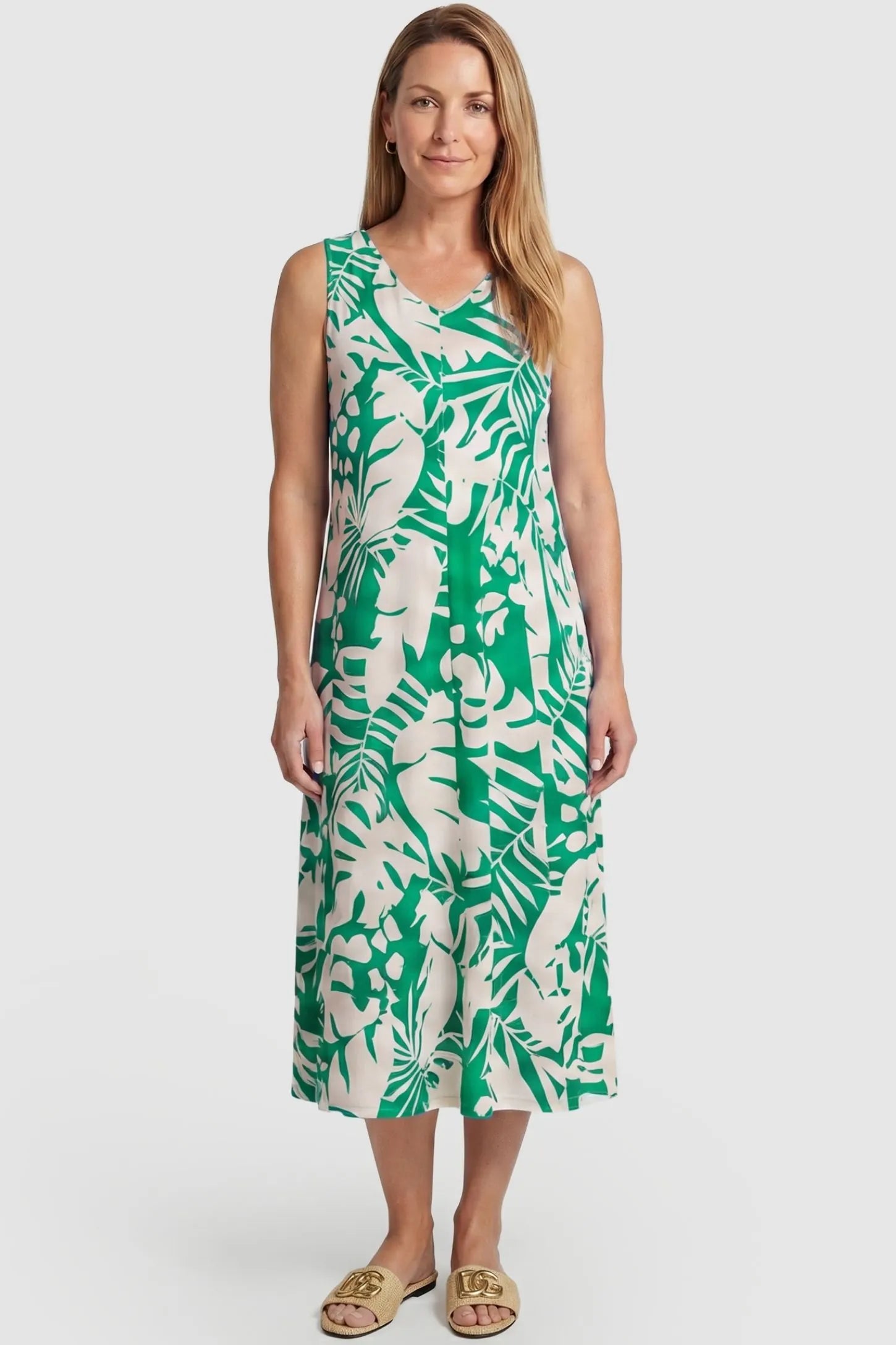 Tropical Print Sleeveless Midi Maternity Dress Tropical Print Sleeveless Midi Maternity Dress in Green featuring a flowy midi silhouette on a postpartum model, front view.