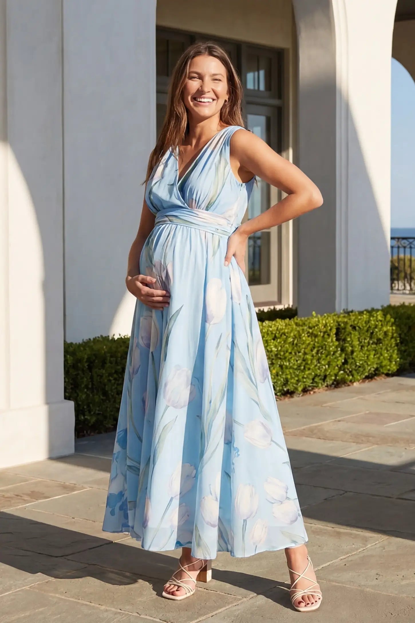 Tulip Print V-Neck Maxi Dress in Blue featuring a watercolor tulip print on a pregnant model, front view.
