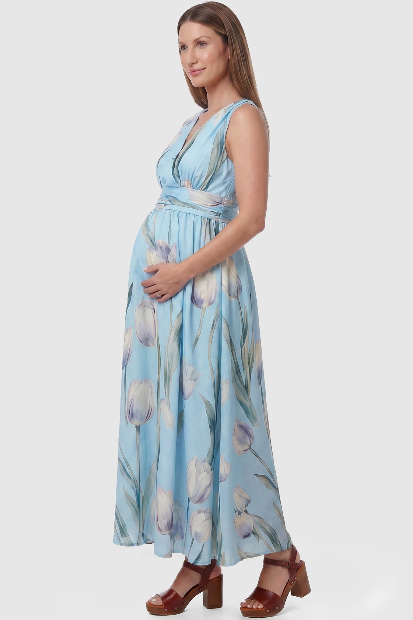 Tulip Print V-Neck Maxi Dress Tulip Print V-Neck Maxi Dress in Blue featuring a watercolor tulip print on a pregnant model, side view.