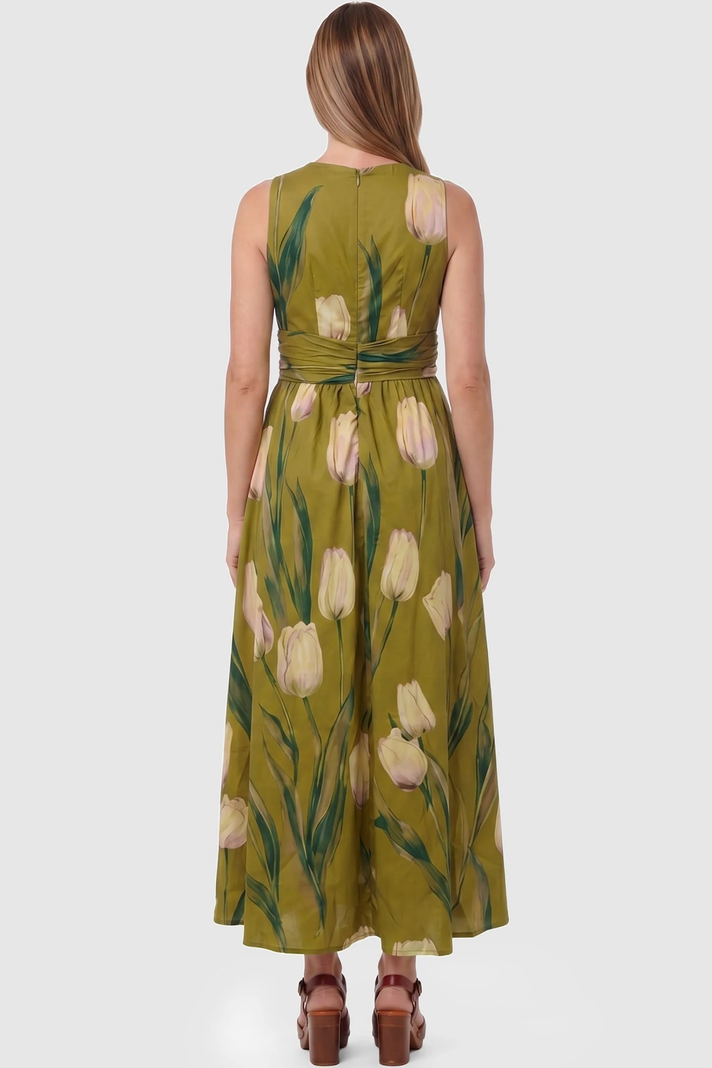 Tulip Print V-Neck Maxi Dress Tulip Print V-Neck Maxi Dress in Green featuring a bold botanical tulip print on a pregnant model, back view.