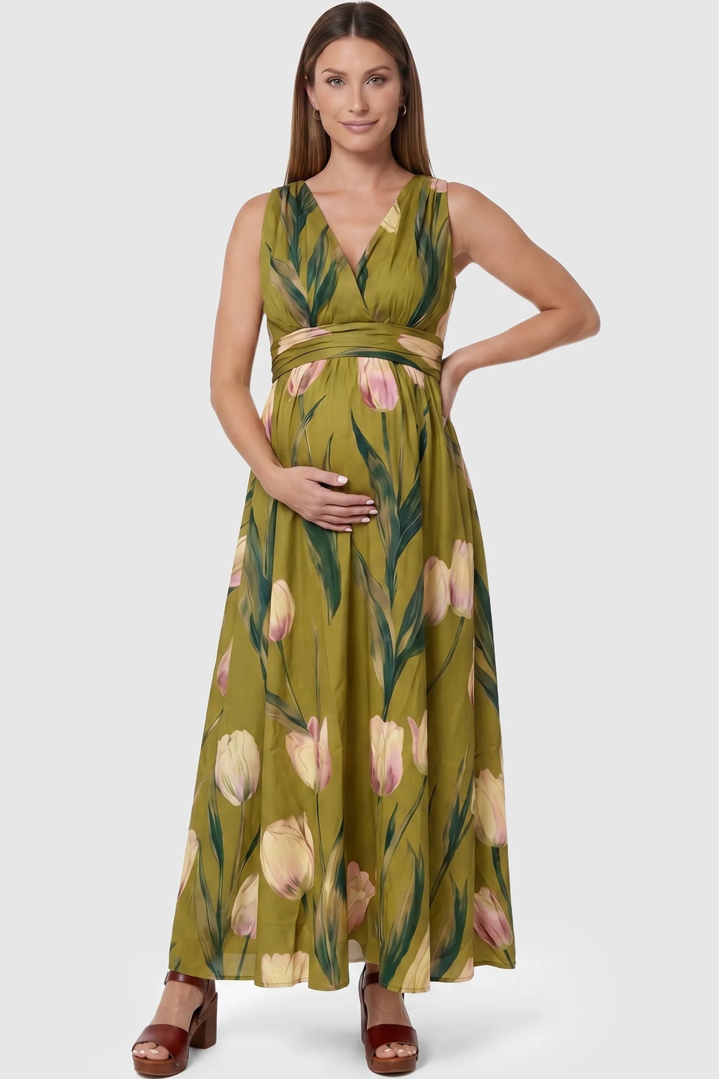 Tulip Print V-Neck Maxi Dress Tulip Print V-Neck Maxi Dress in Green featuring a bold botanical tulip print on a pregnant model, front view.