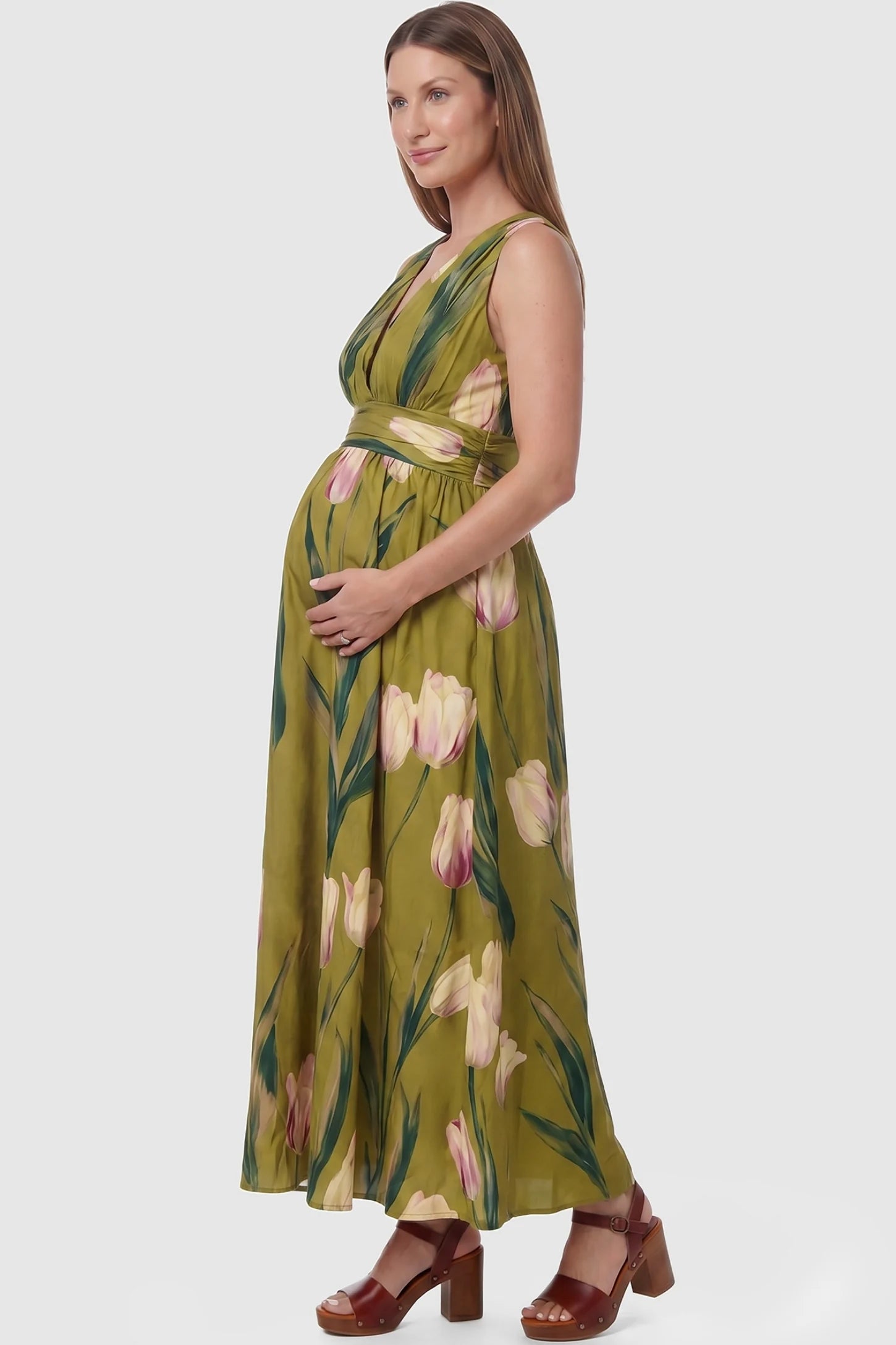 Tulip Print V-Neck Maxi Dress Tulip Print V-Neck Maxi Dress in Green featuring a bold botanical tulip print on a pregnant model, side view.