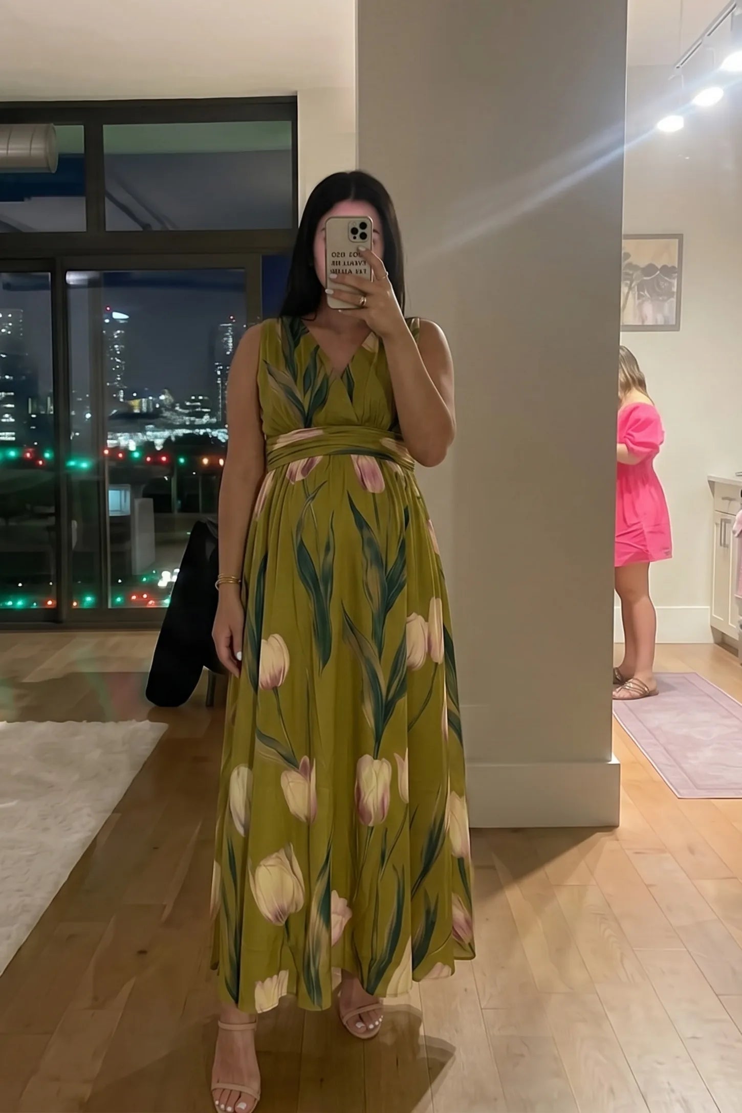 Tulip Print V-Neck Maxi Dress Tulip Print V-Neck Maxi Dress in Green featuring a bold botanical tulip print on a pregnant model, front view.