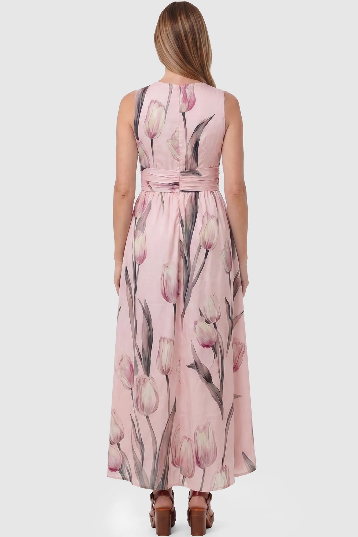 Tulip Print V-Neck Maxi Dress Tulip Print V-Neck Maxi Dress in Pink featuring a soft watercolor tulip print on a pregnant model, back view.