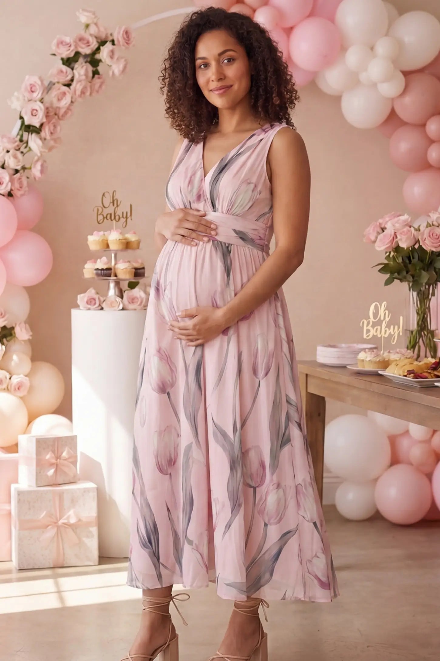 Tulip Print V-Neck Maxi Dress Tulip Print V-Neck Maxi Dress in Pink featuring a soft watercolor tulip print on a pregnant model, front view.