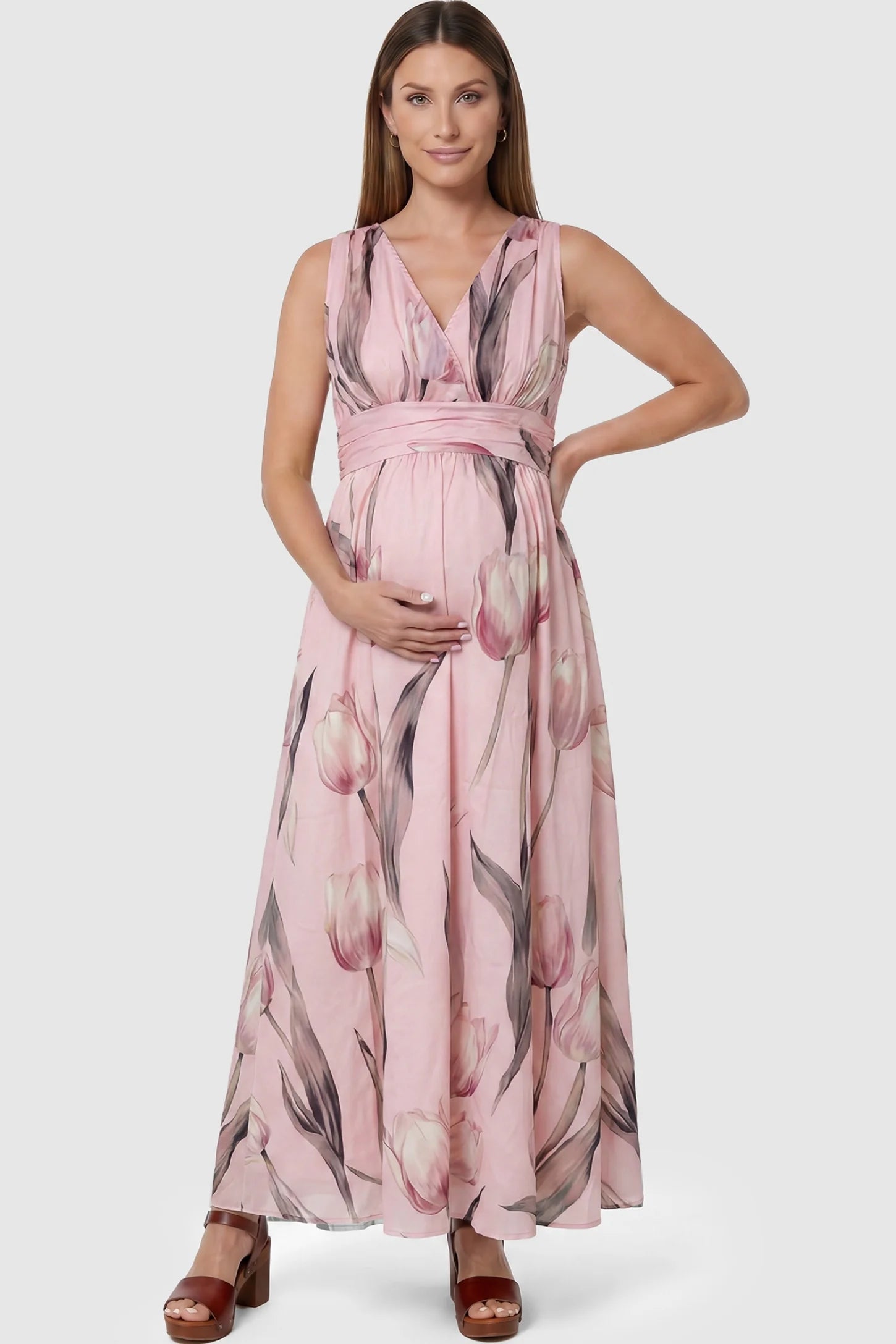 Tulip Print V-Neck Maxi Dress Tulip Print V-Neck Maxi Dress in Pink featuring a soft watercolor tulip print on a pregnant model, front view.