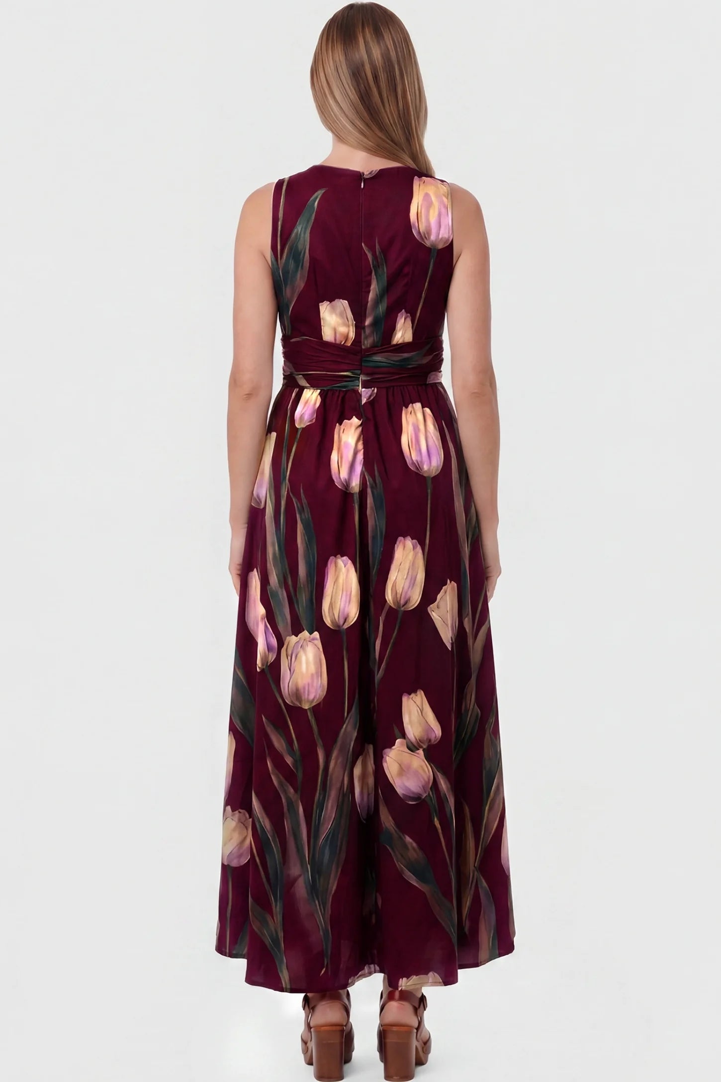 Tulip Print V-Neck Maxi Dress Tulip Print V-Neck Maxi Dress in Wine Red featuring a vibrant tulip floral print on a pregnant model, back view.