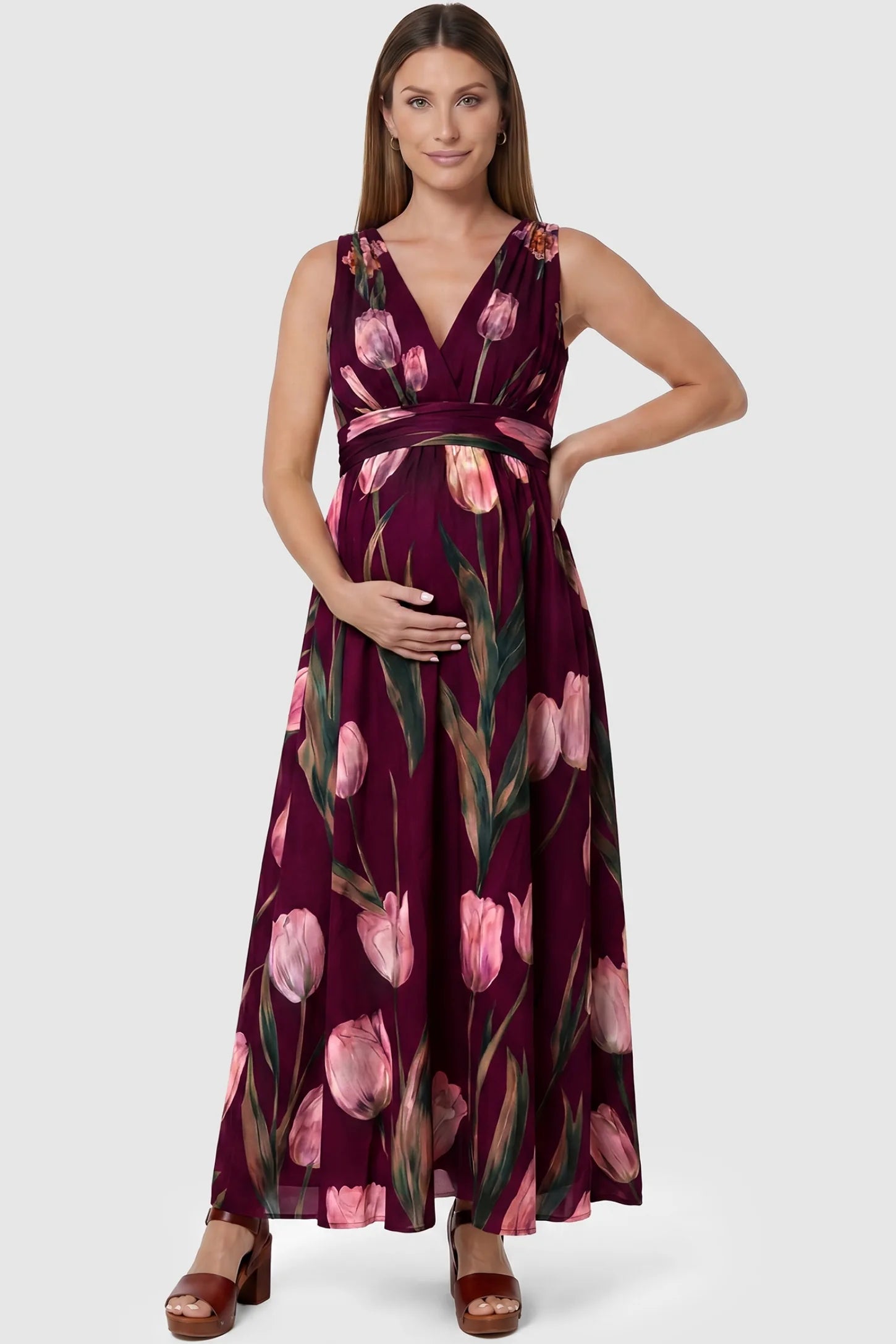 Tulip Print V-Neck Maxi Dress Tulip Print V-Neck Maxi Dress in Wine Red featuring a vibrant tulip floral print on a pregnant model, front view.