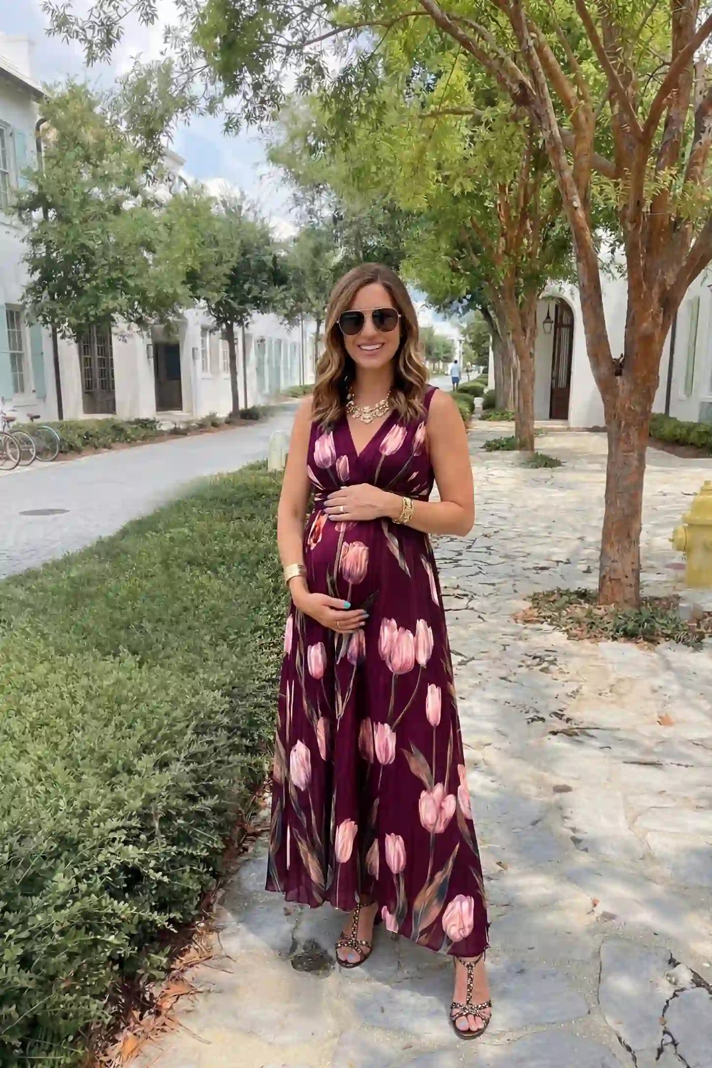 Tulip Print V-Neck Maxi Dress Tulip Print V-Neck Maxi Dress in Wine Red featuring a vibrant tulip floral print on a pregnant model, front view.