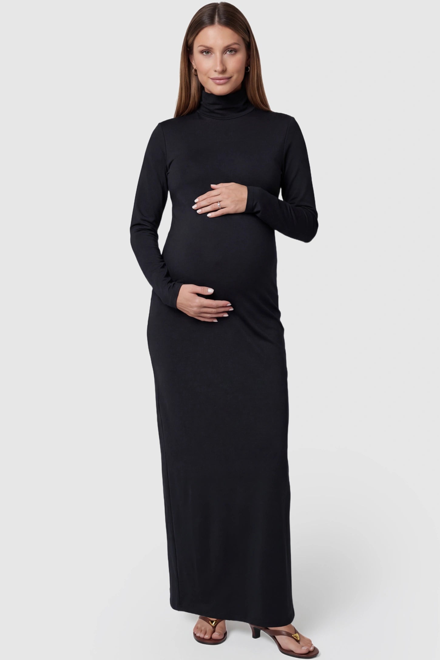 Turtle Neck Long Sleeve Maternity Maxi Dress in Black featuring a turtleneck and long sleeves on a pregnant model, front view.