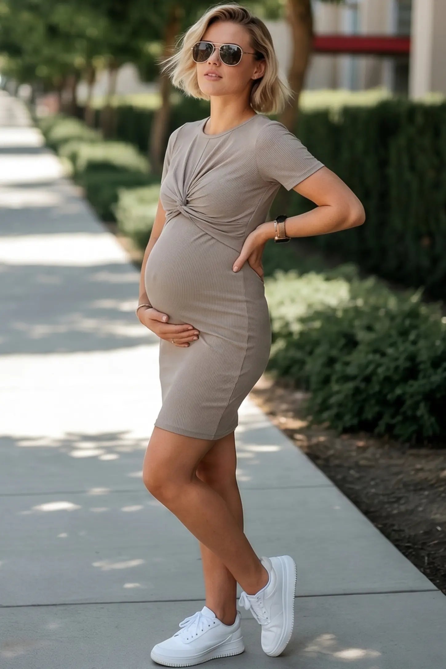 Twist Front Round Neck Short Sleeve Maternity Short Dress Twist Front Round Neck Maternity Short Dress in gray featuring side ruched panels on a pregnant woman in outdoor setting, side view.