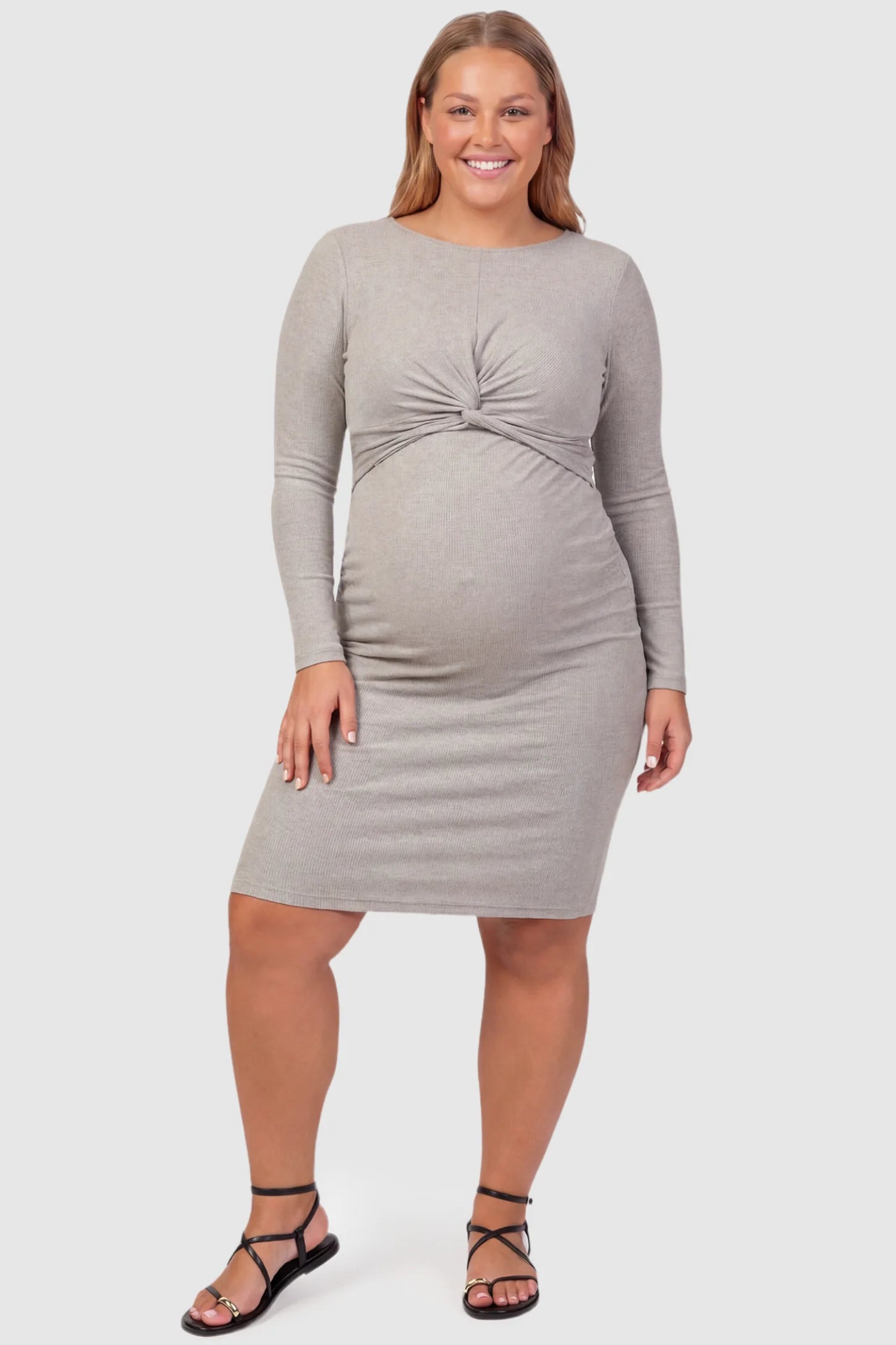 Twist Front Round Neck Short Sleeve Maternity Short Dress Twist Front Round Neck Maternity Short Dress in gray featuring side ruched panels on a plus size pregnant model, front view.