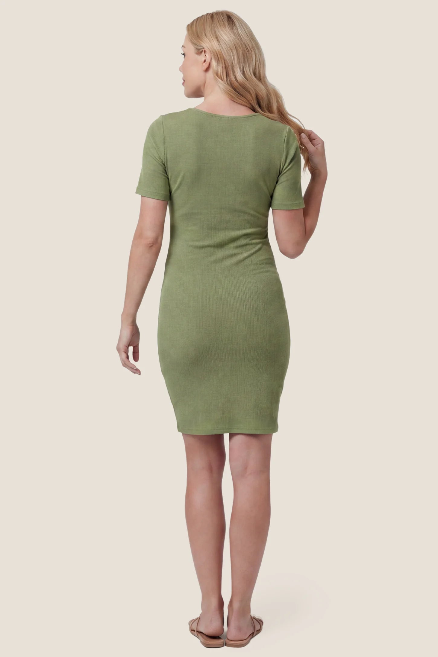 Twist Front Round Neck Short Sleeve Maternity Short Dress Twist Front Round Neck Maternity Short Dress in green featuring short sleeves. soft knit stretch on a pregnant model, back view.