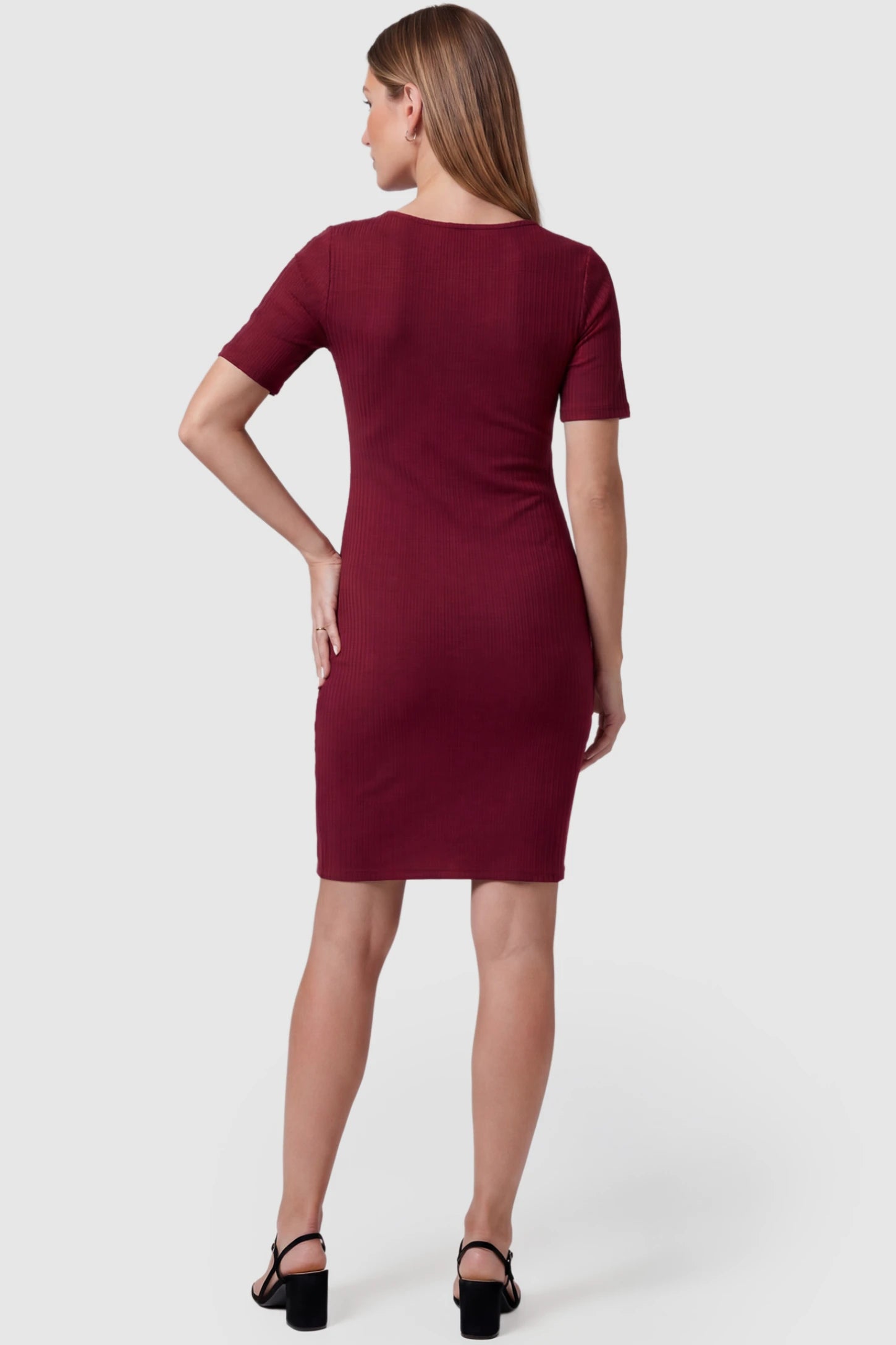 Twist Front Round Neck Short Sleeve Maternity Short Dress Twist Front Round Neck Maternity Short Dress in wine red featuring short sleeves. soft knit stretch on a pregnant model, back view.