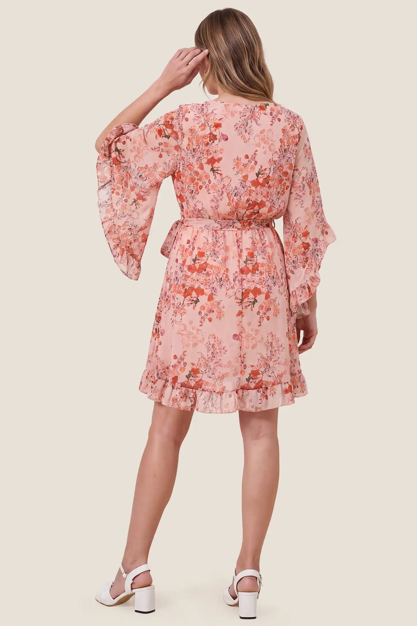 V-Neck Bell Sleeve Long Sleeve Maternity Dress V-Neck Bell Sleeve Long Sleeve Maternity Dress in Blush Floral showcasing the flattering short silhouette on a pregnant model, studio back view.