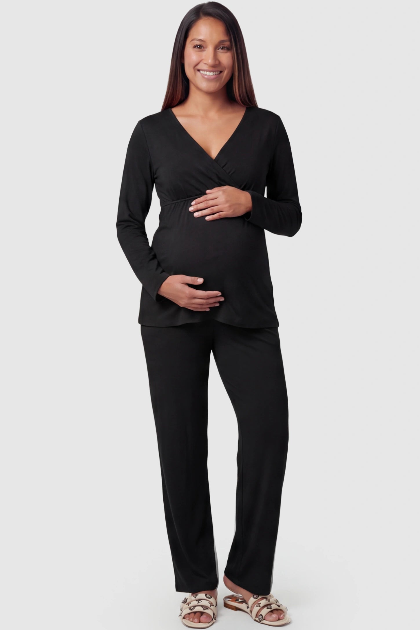 V-Neck Long Sleeve Top with Long Pants Maternity Sleepwear V-Neck Long Sleeve Maternity Lounge Set in Black featuring a crossover front on a pregnant model showing fullbody.