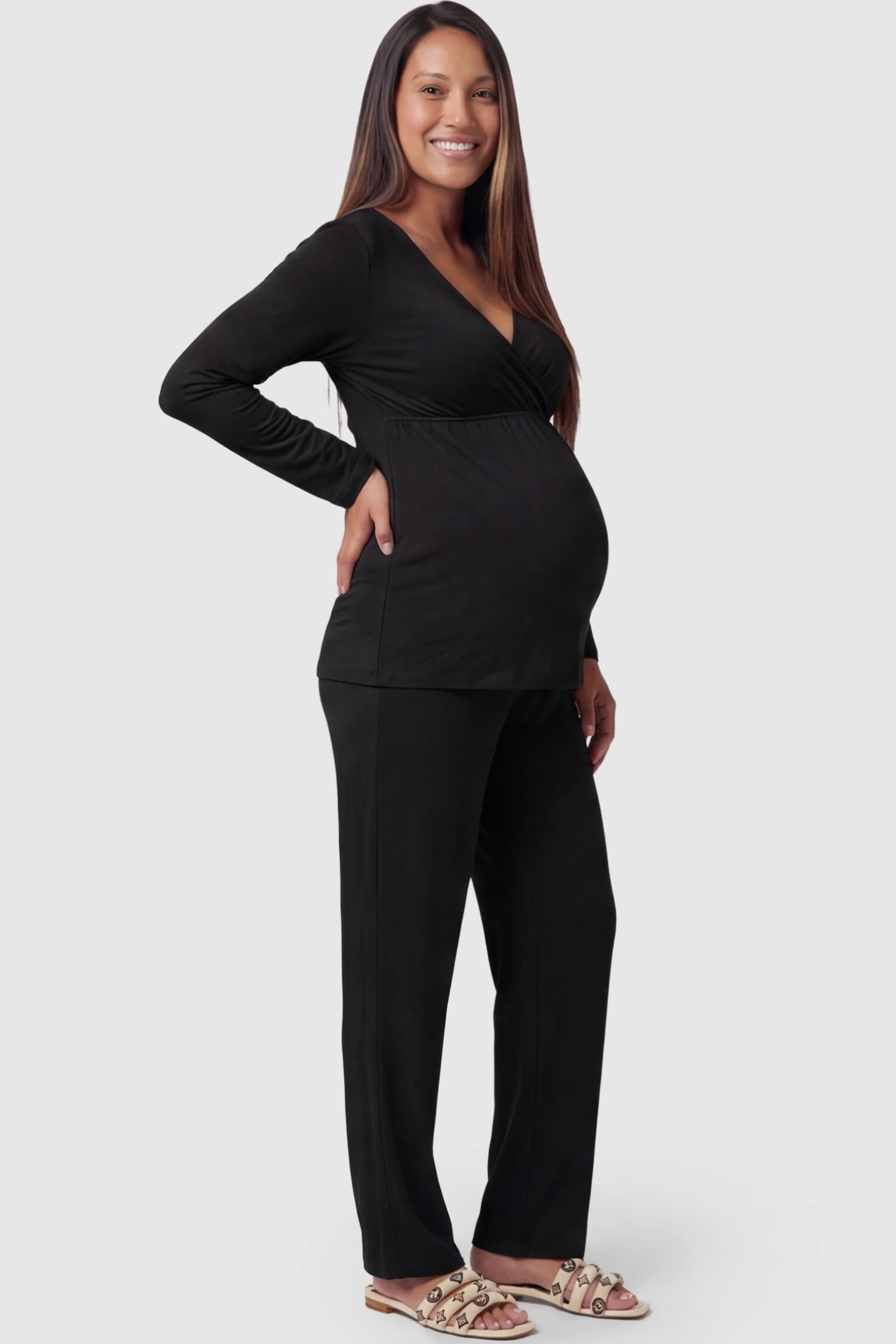 V-Neck Long Sleeve Top with Long Pants Maternity Sleepwear V-Neck Long Sleeve Maternity Lounge Set in Black featuring a crossover front on a pregnant model showing side.