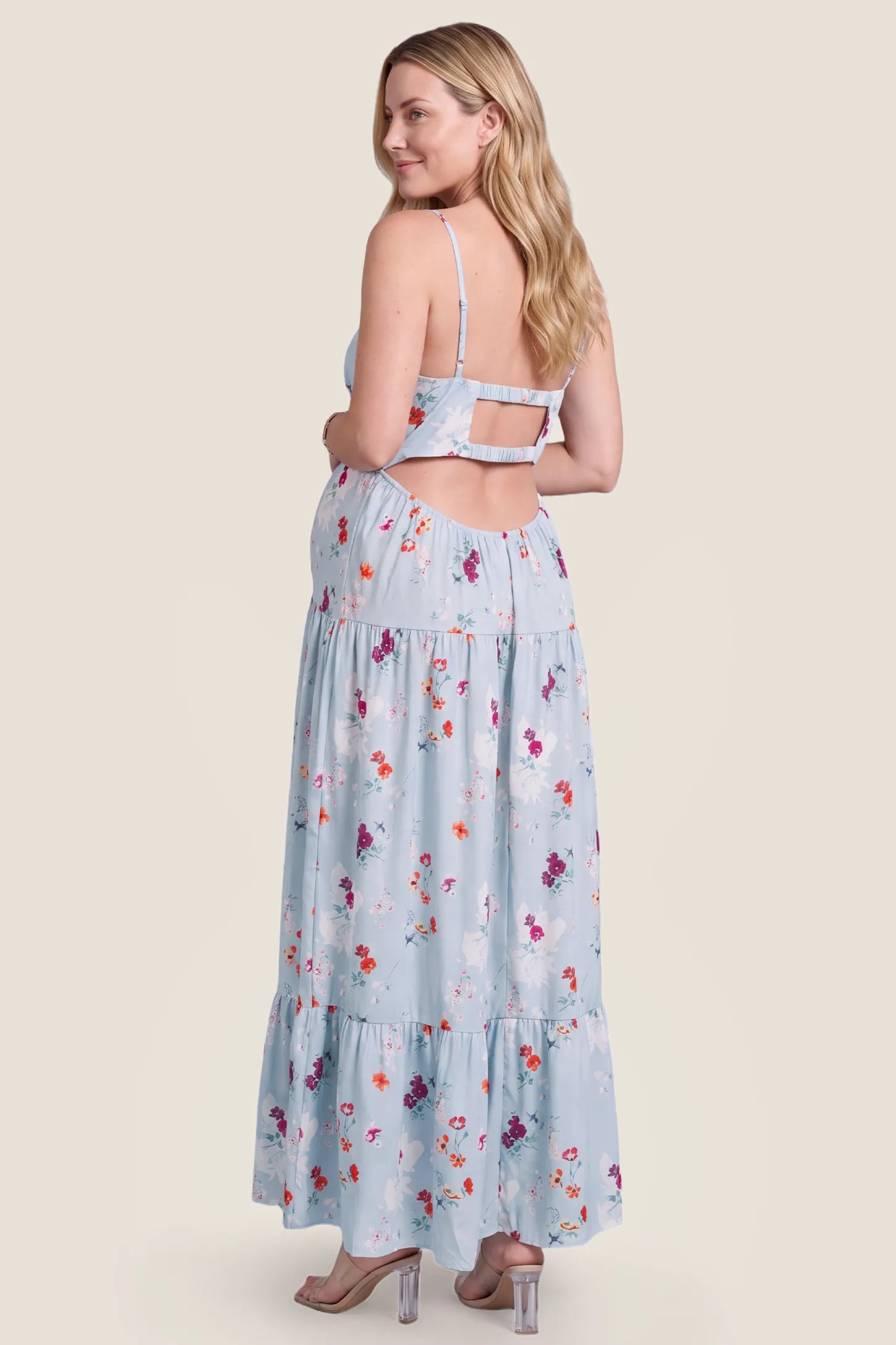 V-Neck Open Back Maternity Maxi Dress V-Neck Open Back Maternity Maxi Dress in Light Blue Floral detailing the backless design and straps on a pregnant model, studio back view.
