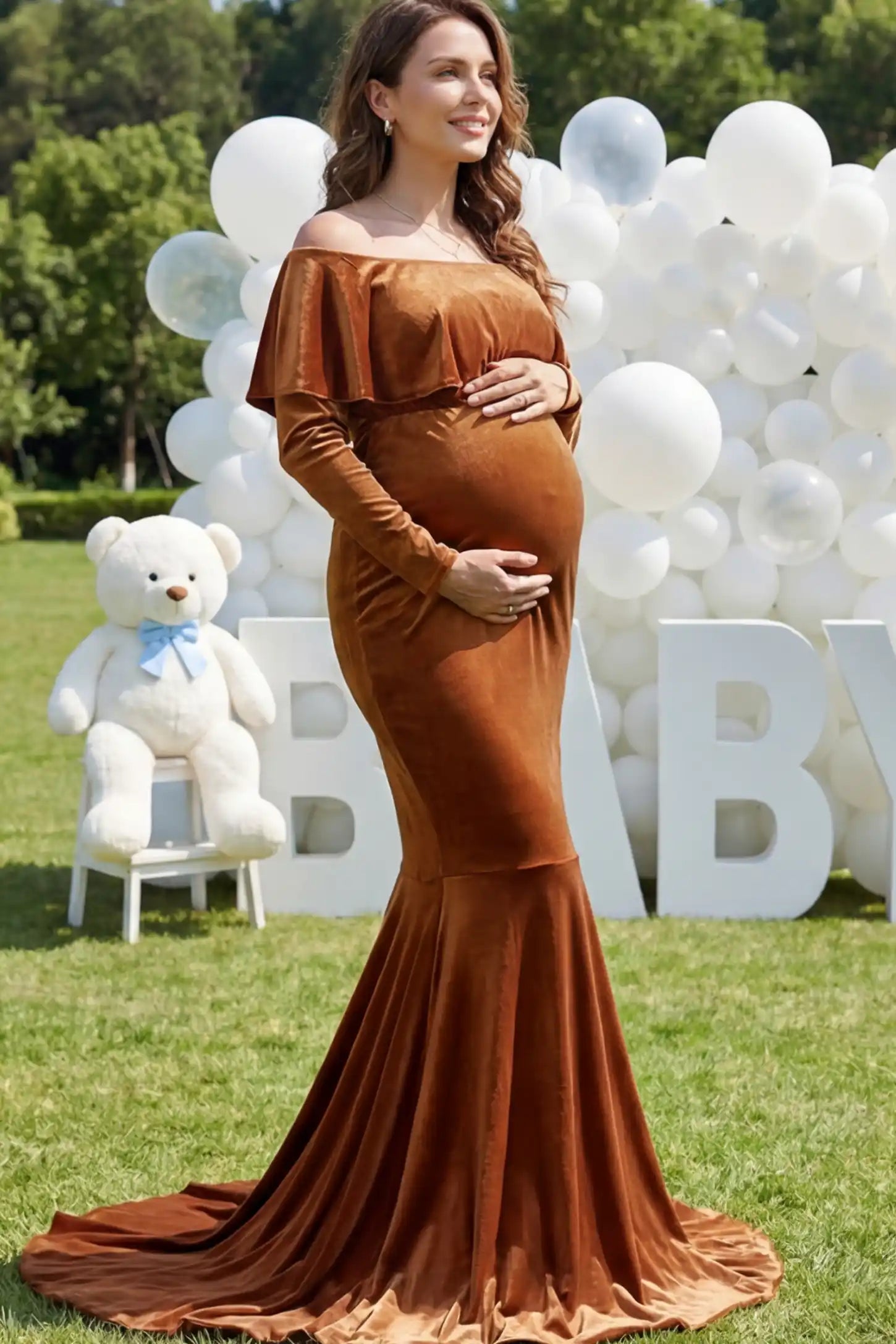Velvet Off Shoulder Long Sleeve Maternity Mermaid Gown Velvet Off-the-Shoulder Maternity Mermaid Gown in Brown featuring a ruffled neckline and long sleeves on a pregnant model.