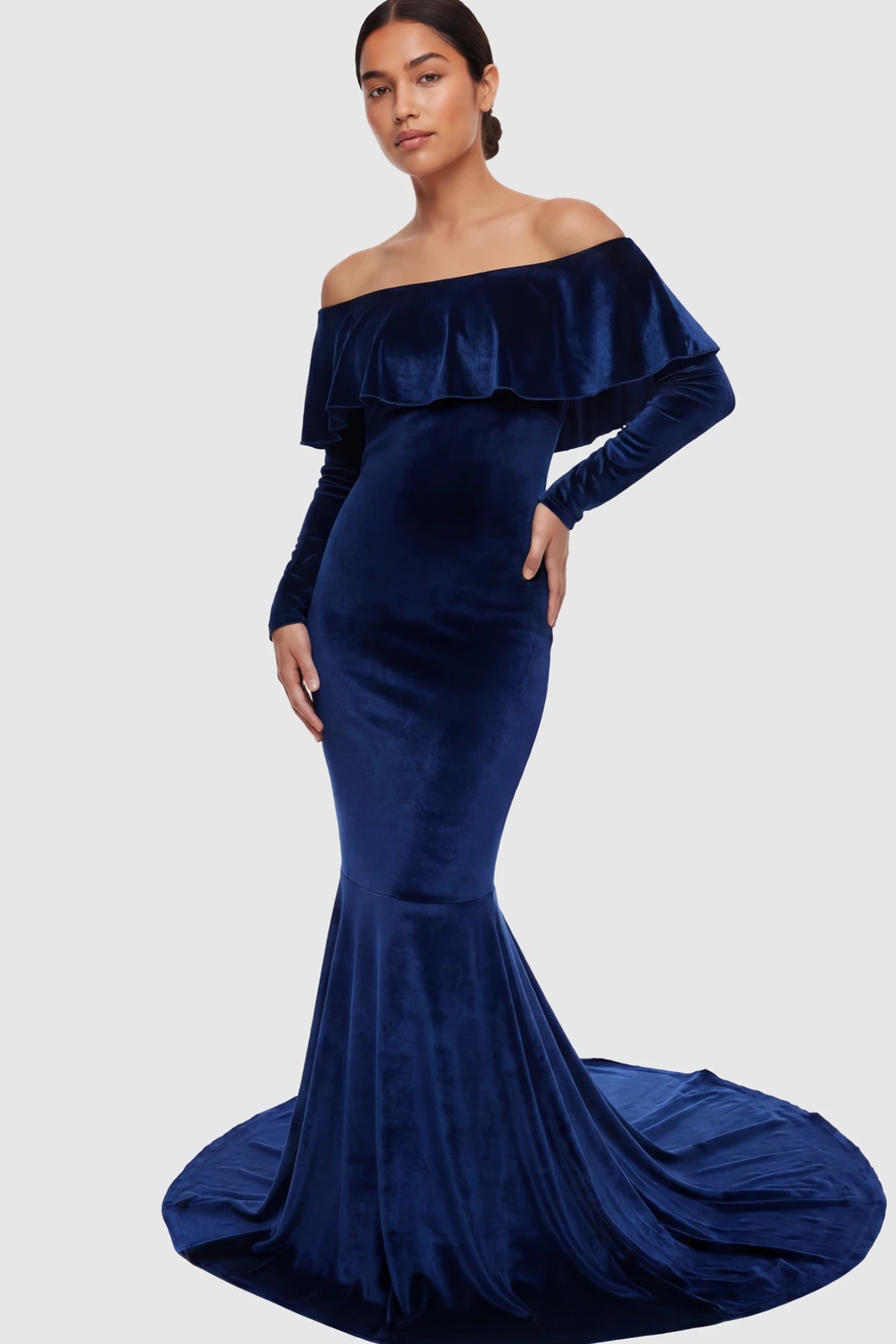 Velvet Off Shoulder Long Sleeve Maternity Mermaid Gown Velvet Off-the-Shoulder Maternity Mermaid Gown in Dark Blue featuring a ruffled neckline and long sleeves on a postpartum model.