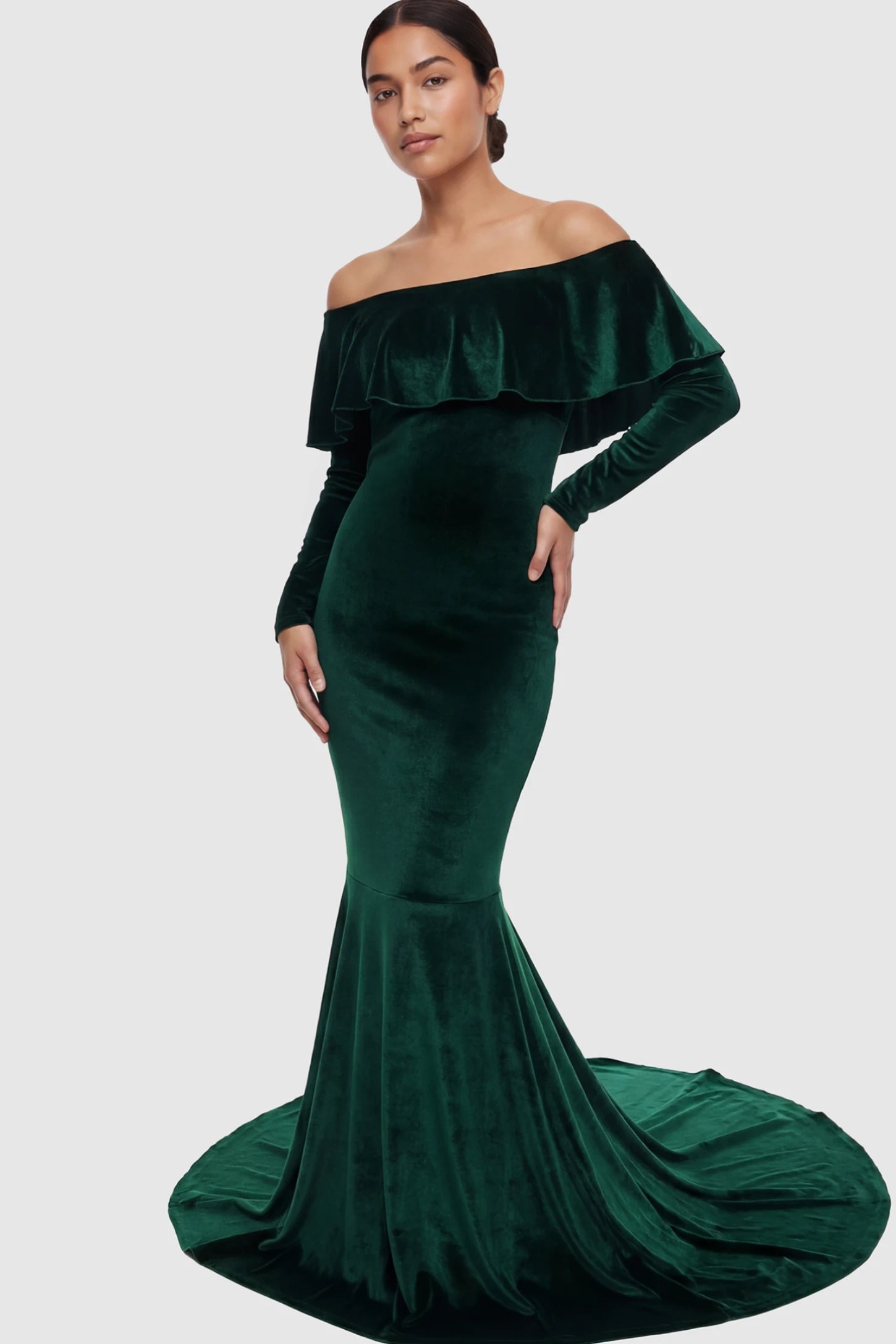 Velvet Off Shoulder Long Sleeve Maternity Mermaid Gown Velvet Off-the-Shoulder Maternity Mermaid Gown in Green featuring a ruffled neckline and long sleeves on a postpartum model.