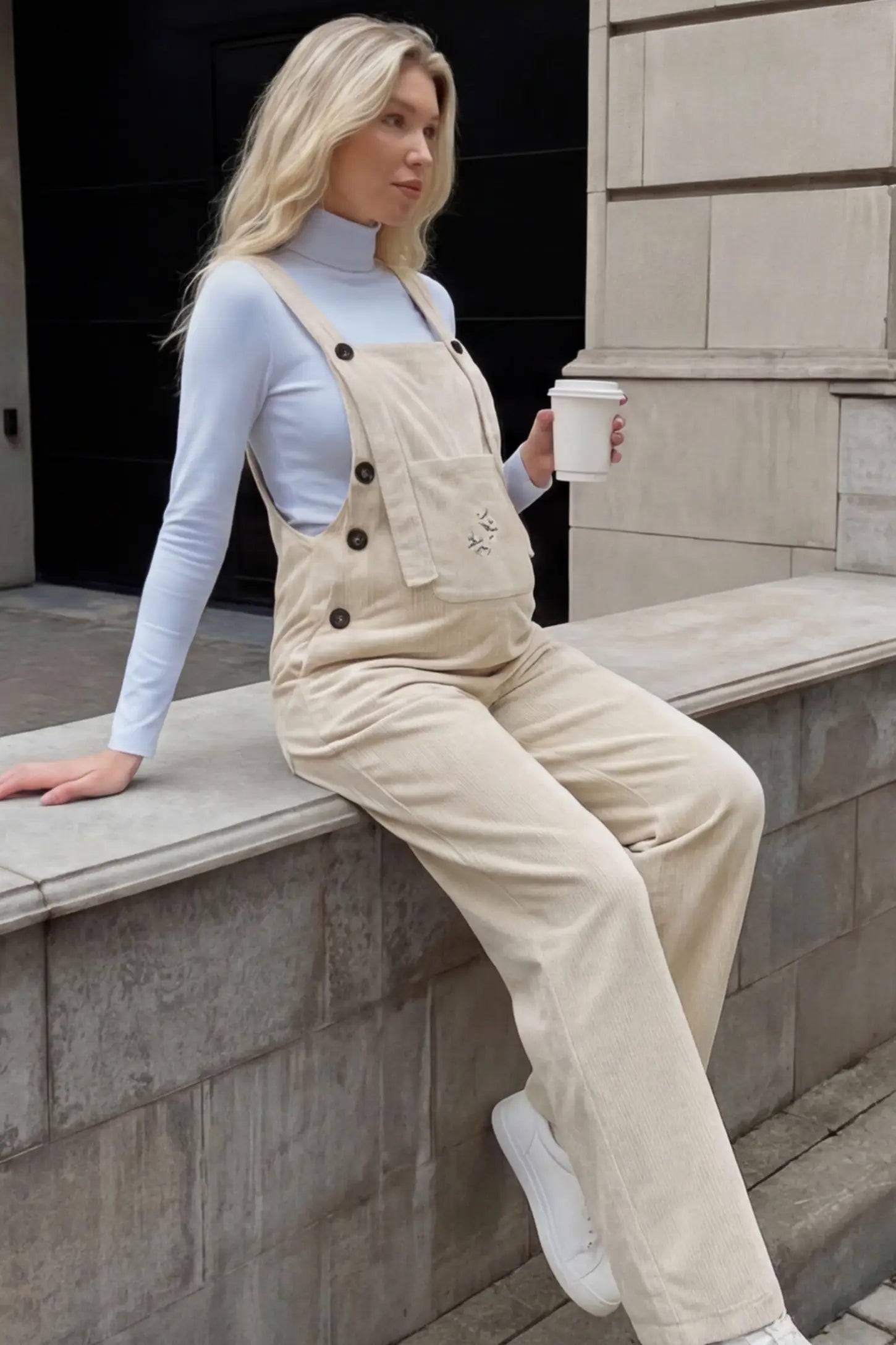 Adjustable Strap Wide-Leg Corduroy Maternity Overalls Floral Embroidered Wide-Leg Maternity Overalls in apricot featuring adjustable straps on a pregnant woman in outdoor setting, side view.