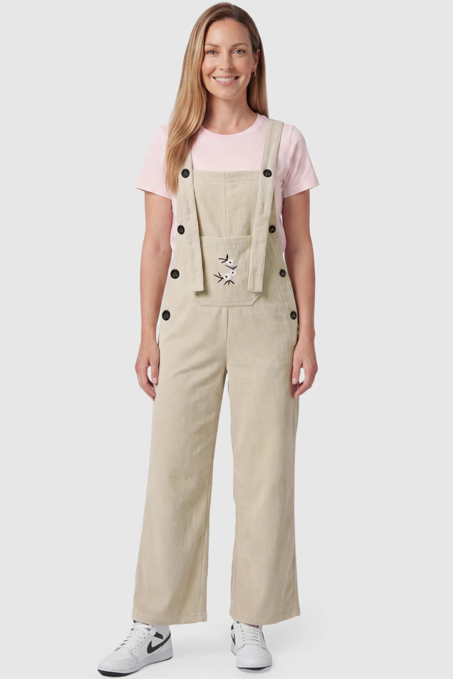 Adjustable Strap Wide-Leg Corduroy Maternity Overalls Floral Embroidered Wide-Leg Maternity Overalls in apricot featuring adjustable straps on a postpartum model, front view.