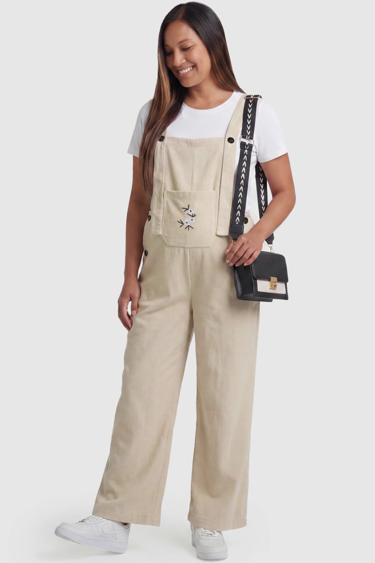 Floral Embroidered Wide-Leg Maternity Overalls in apricot featuring adjustable straps on a pregnant model, front view.