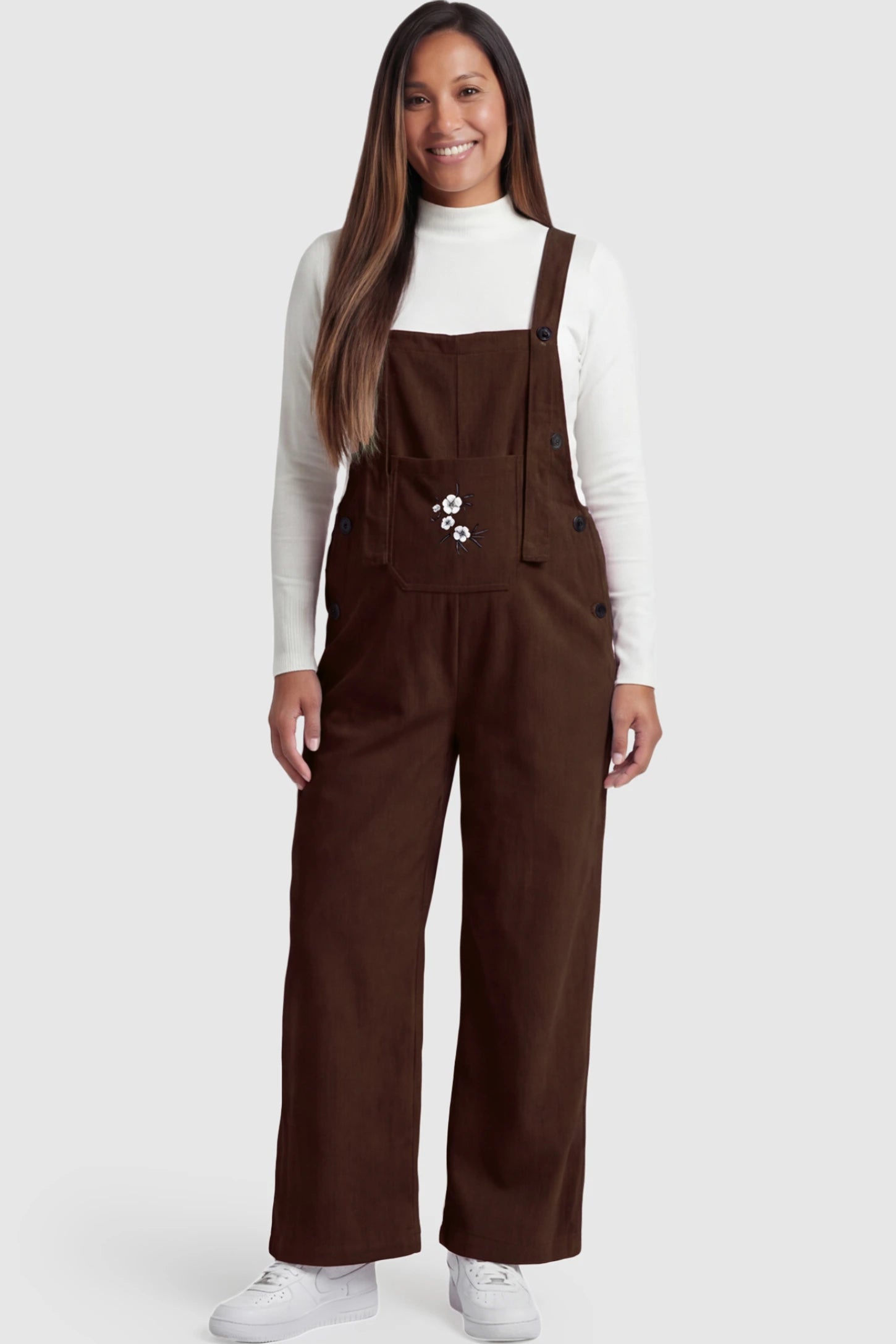 Adjustable Strap Wide-Leg Corduroy Maternity Overalls Floral Embroidered Wide-Leg Maternity Overalls in brown featuring adjustable straps on a pregnant model posing front.