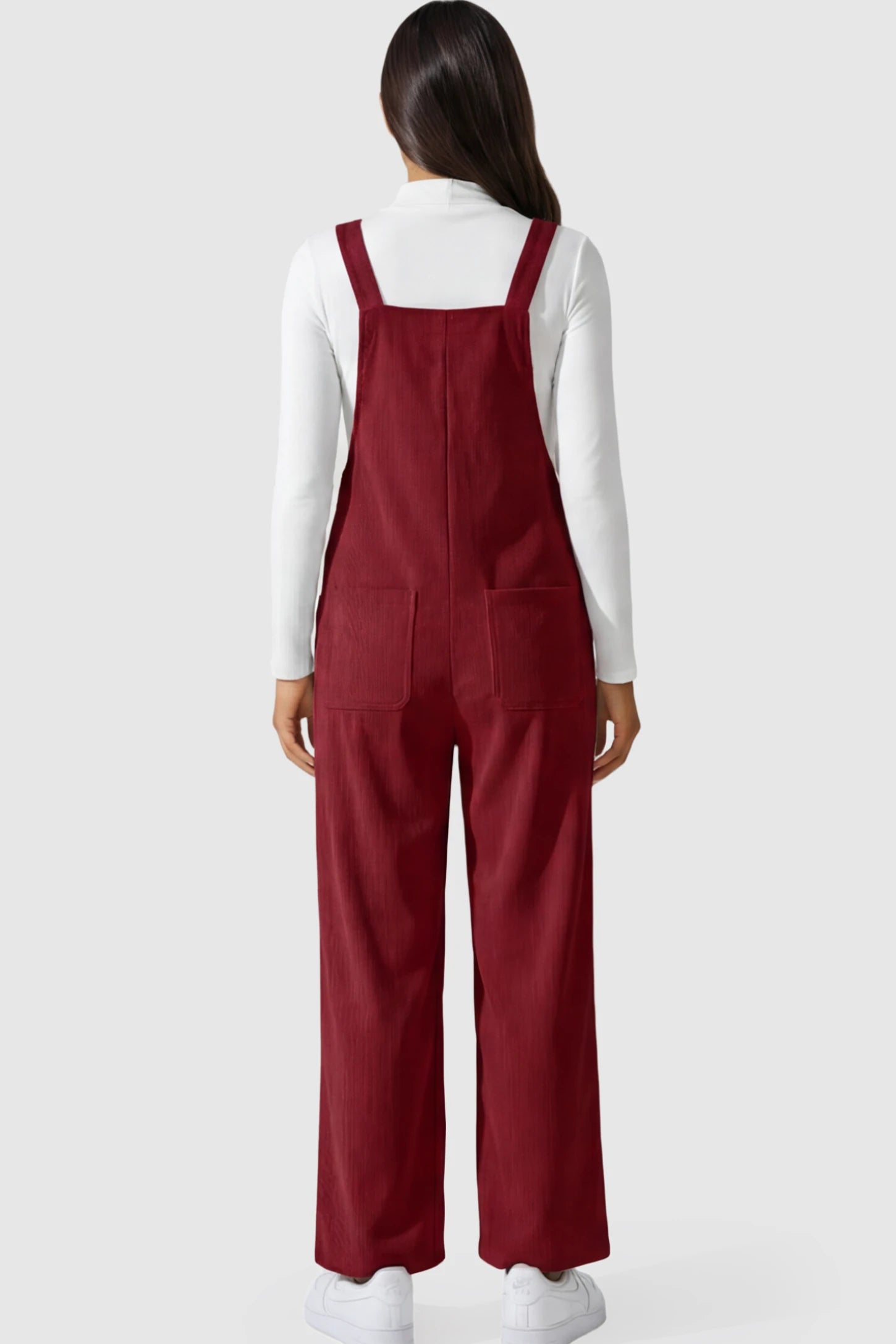 Adjustable Strap Wide-Leg Corduroy Maternity Overalls Floral Embroidered Wide-Leg Maternity Overalls in red featuring corduroy texture and pockets on a pregnant model showing back.