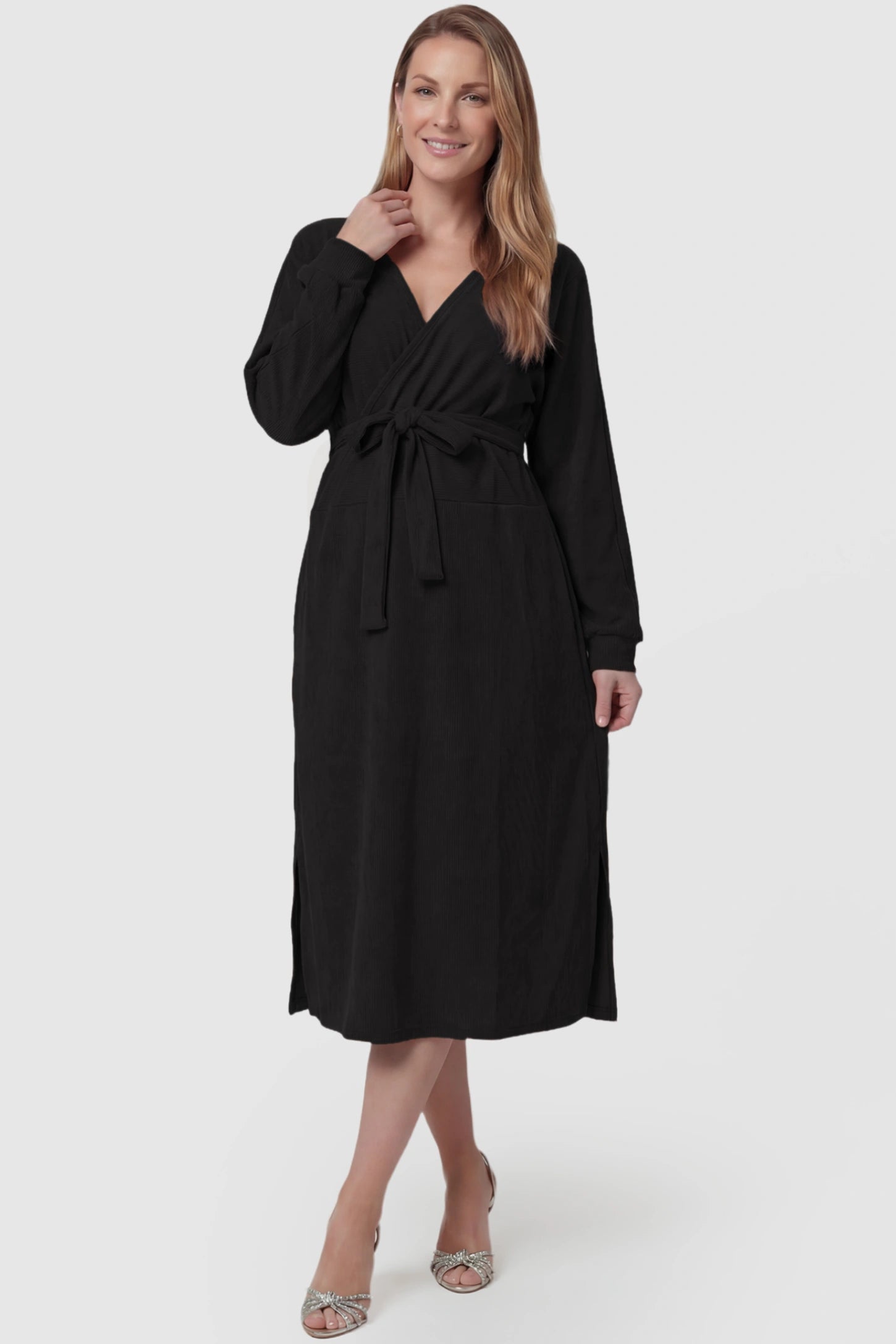 Wrap Front Tie Waist Long Sleeve Maternity Midi Dress Wrap Front Tie Waist Long Sleeve Maternity Midi Dress in Black featuring adjustable tie waist and side slits on a postpartum model, front view.