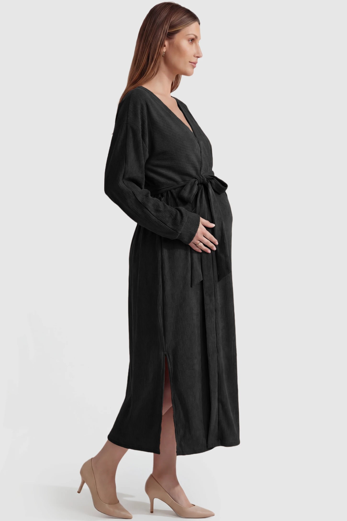Wrap Front Tie Waist Long Sleeve Maternity Midi Dress Wrap Front Tie Waist Long Sleeve Maternity Midi Dress in Black featuring adjustable tie waist and side slits on a pregnant model, side view.
