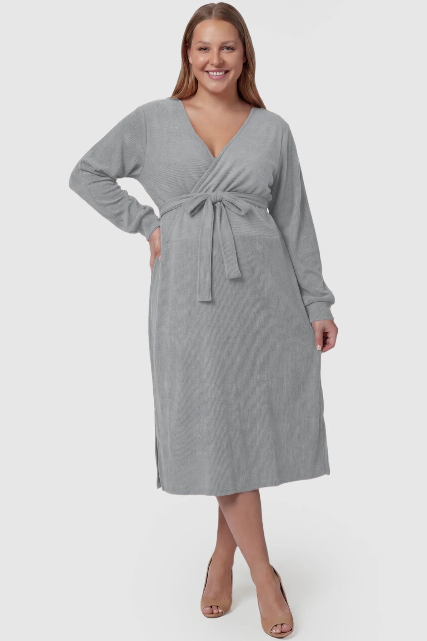 Wrap Front Tie Waist Long Sleeve Maternity Midi Dress Wrap Front Tie Waist Long Sleeve Maternity Midi Dress in Gray featuring adjustable tie waist and side slits on a plus size pregnant model, front view.