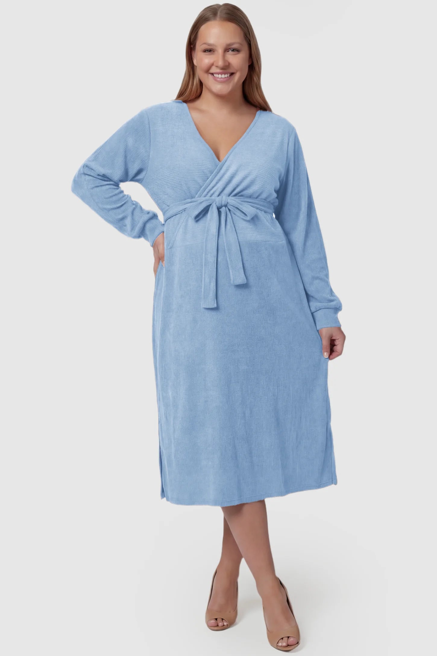 Wrap Front Tie Waist Long Sleeve Maternity Midi Dress Wrap Front Tie Waist Long Sleeve Maternity Midi Dress in Light Blue featuring adjustable tie waist and side slits on a plus size pregnant model, front view.