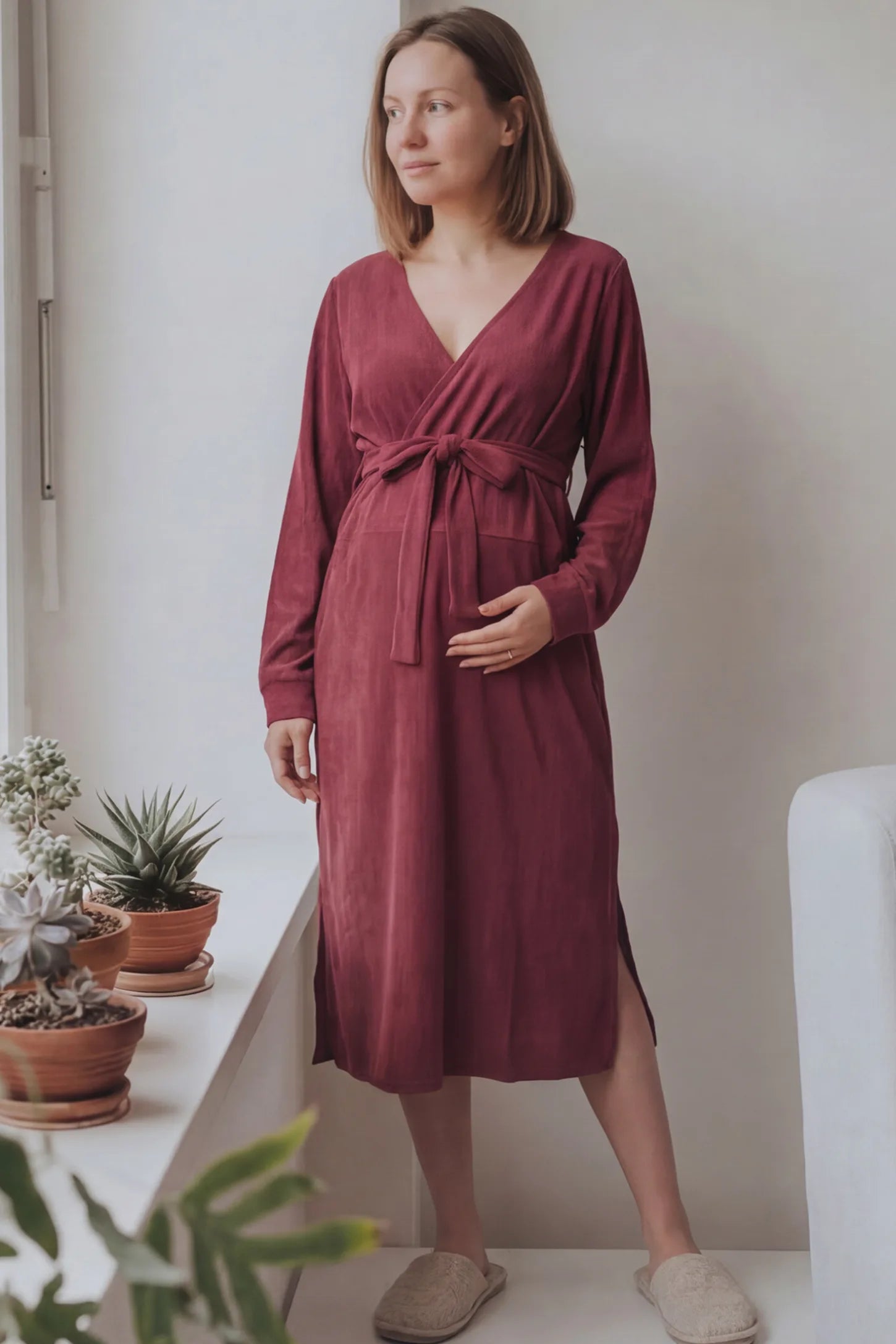 Wrap Front Tie Waist Long Sleeve Maternity Midi Dress Wrap Front Tie Waist Long Sleeve Maternity Midi Dress in Purple featuring adjustable tie waist and side slits on a pregnant woman in outdoor setting, front view.