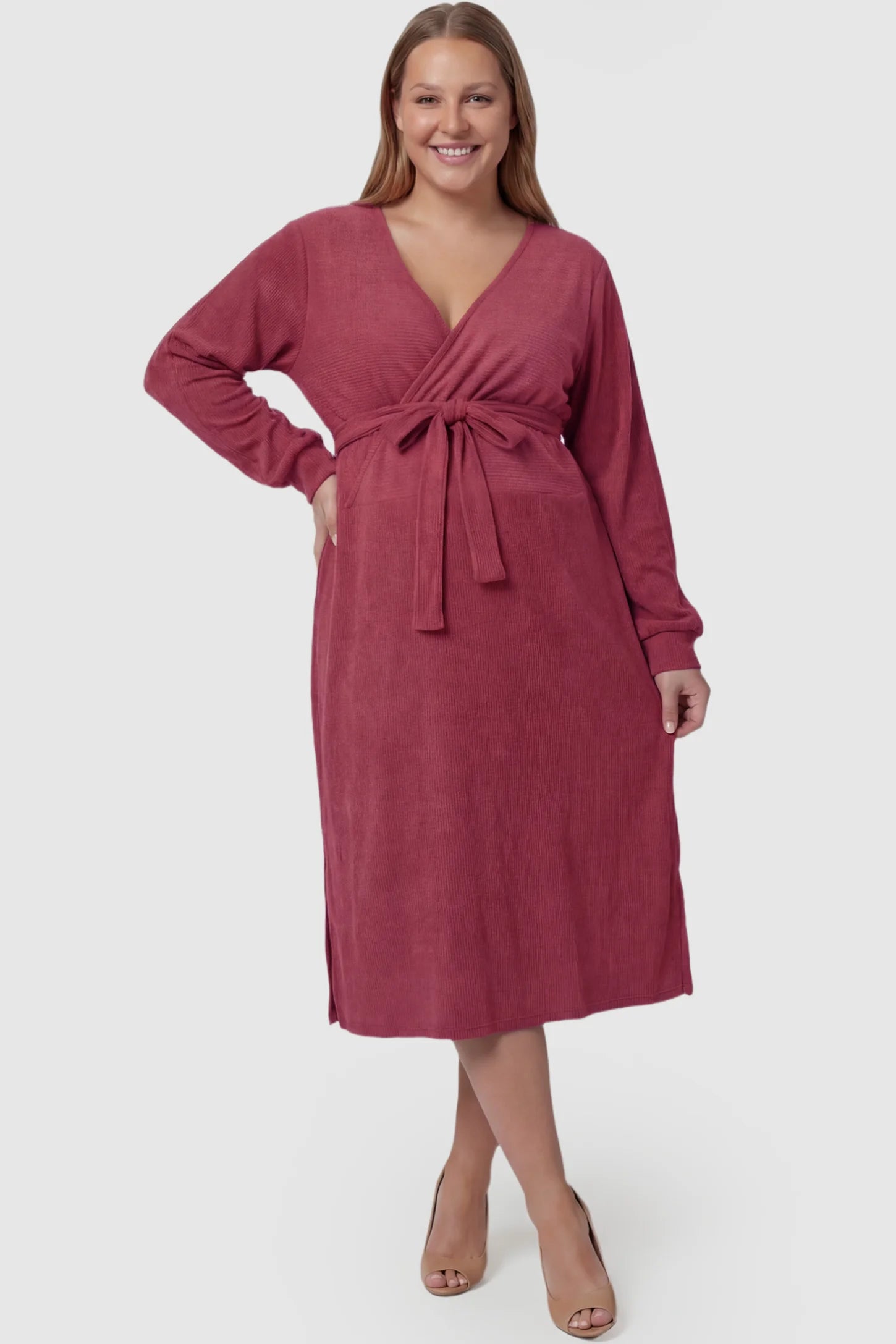 Wrap Front Tie Waist Long Sleeve Maternity Midi Dress Wrap Front Tie Waist Long Sleeve Maternity Midi Dress in Purple featuring adjustable tie waist and side slits on a plus size pregnant model, front view.