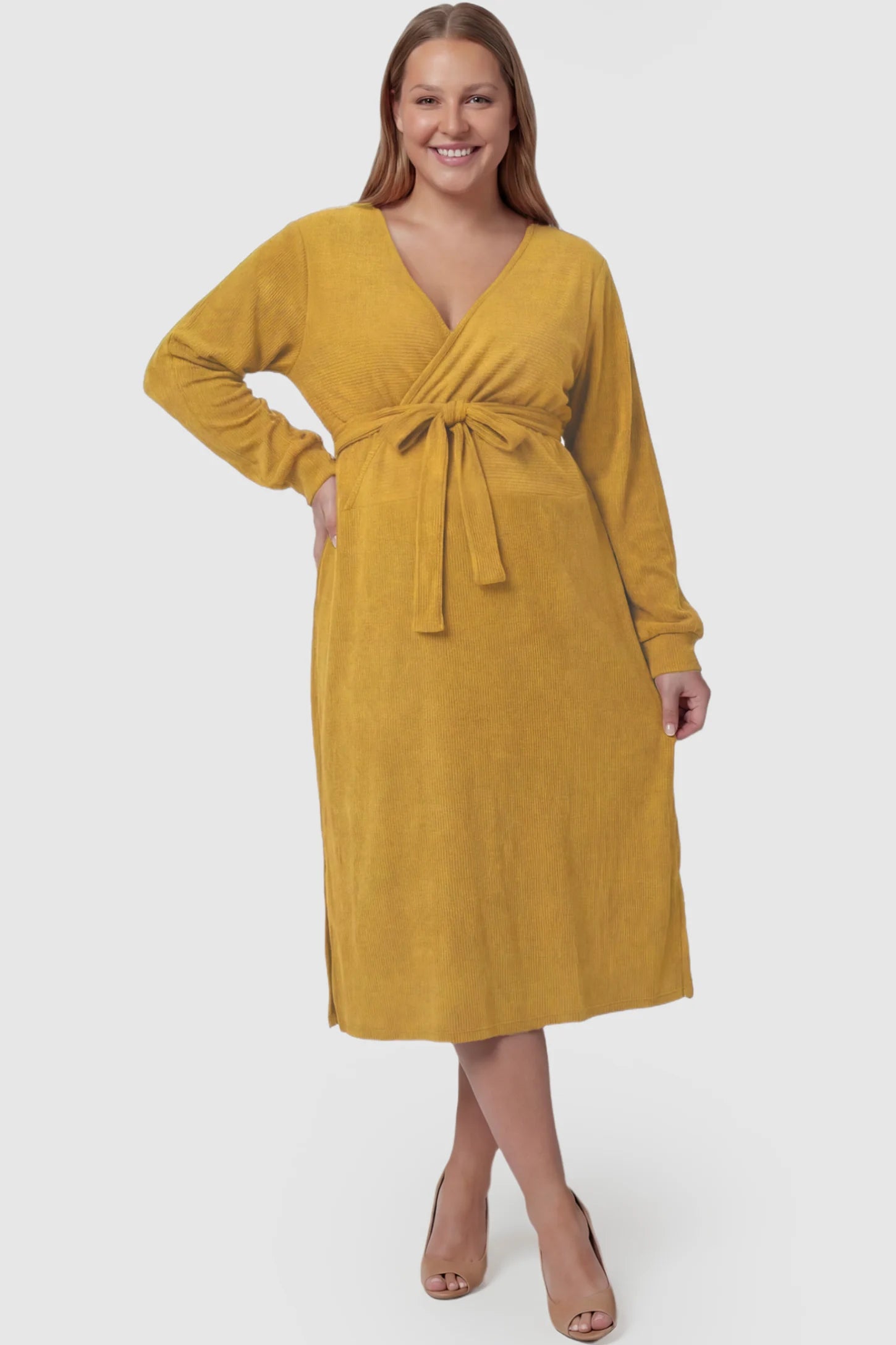 Wrap Front Tie Waist Long Sleeve Maternity Midi Dress Wrap Front Tie Waist Long Sleeve Maternity Midi Dress in Yellow featuring adjustable tie waist and side slits on a plus size pregnant model, front view.
