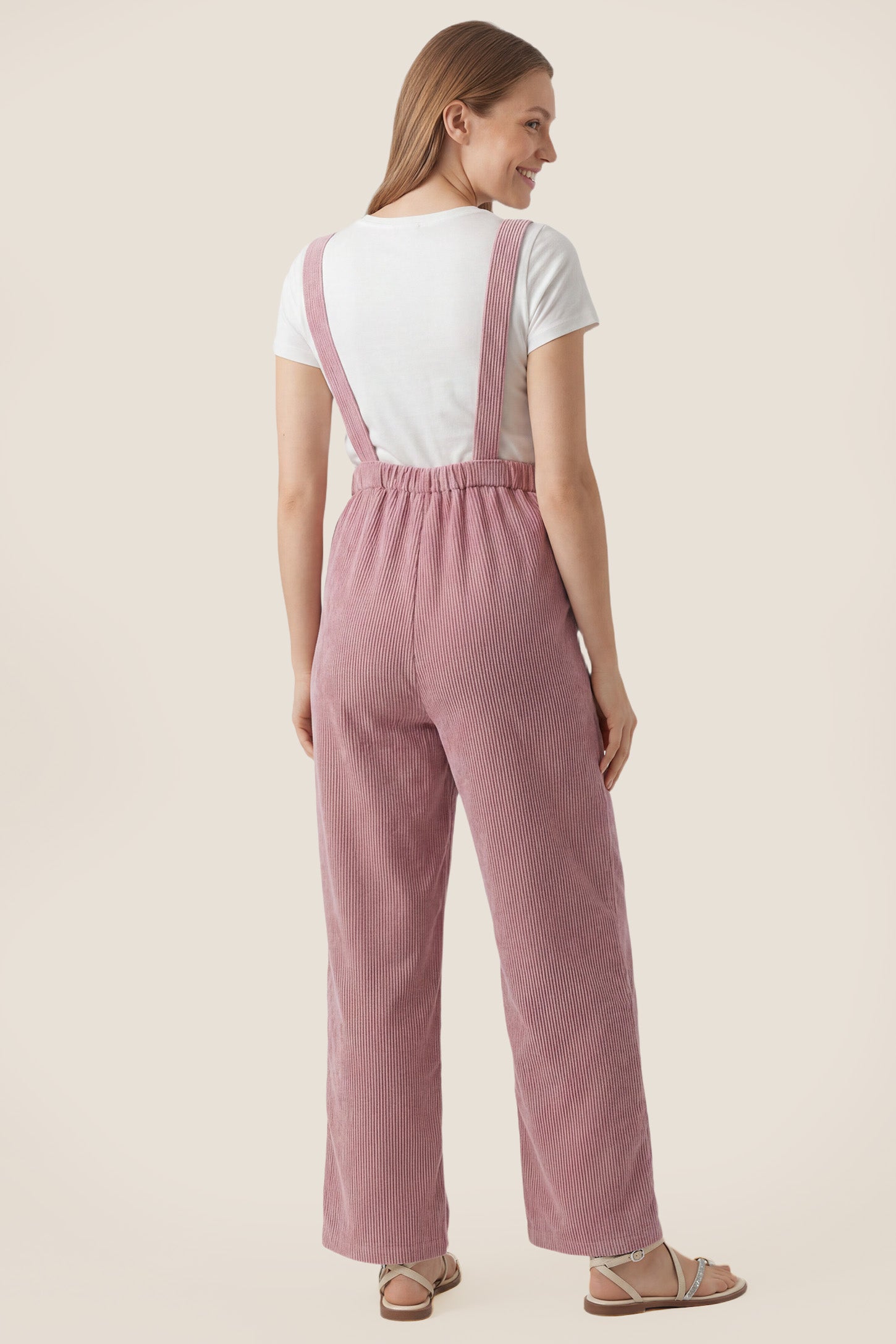 Back view of pink corduroy wide leg maternity jumpsuit