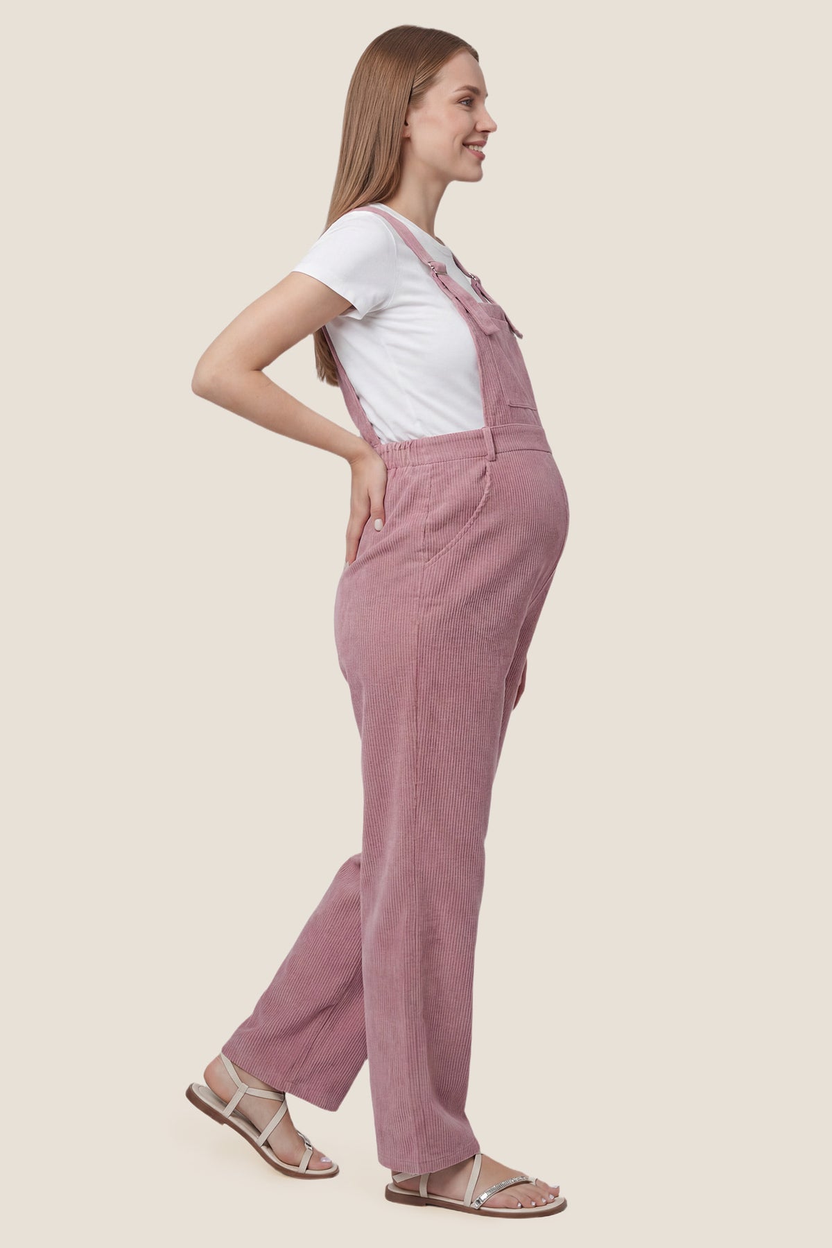 Corduroy Wide Leg Maternity Jumpsuit Side view of pink corduroy wide leg maternity jumpsuit with bump-friendly fit