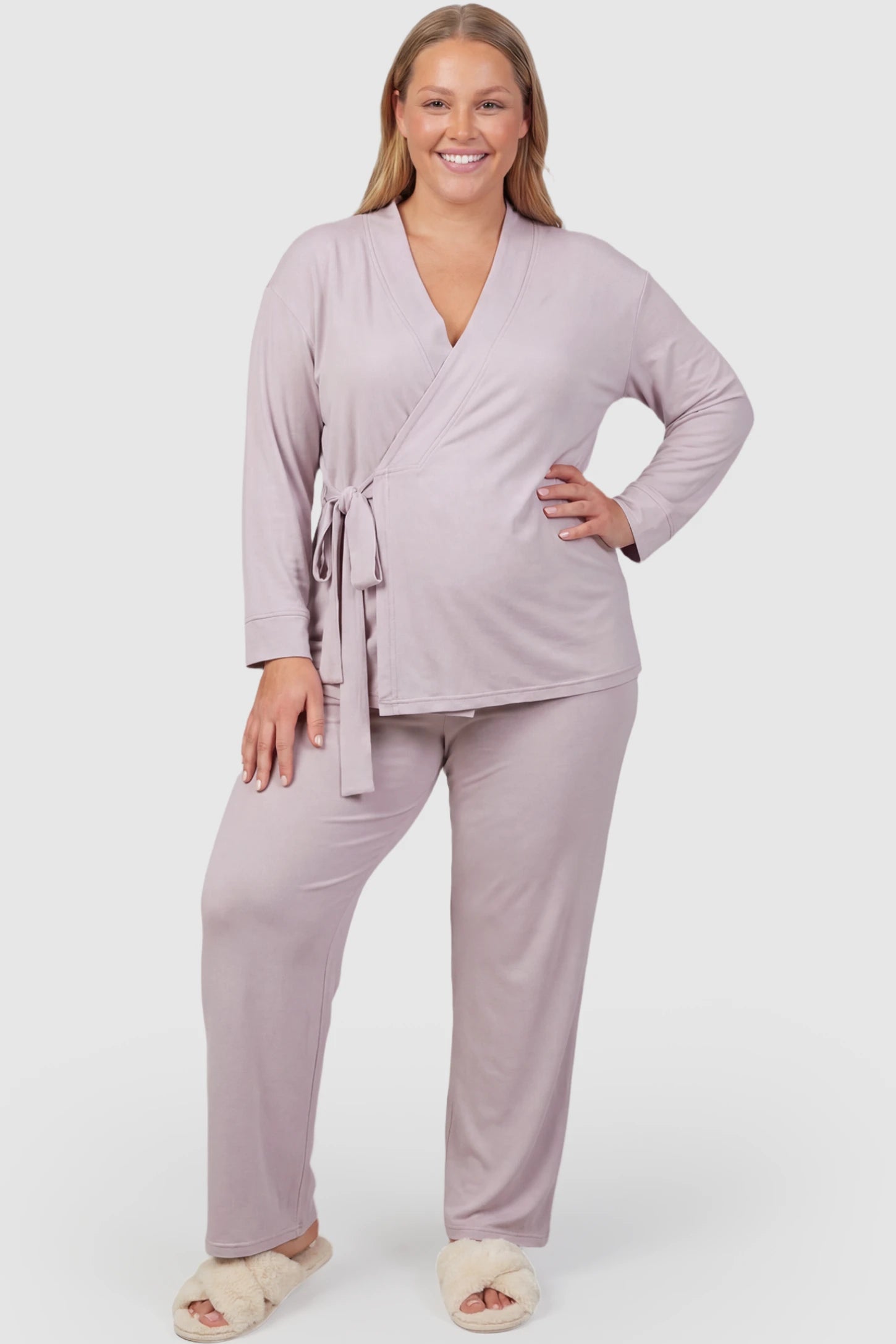 Cotton Wrap Front Long Sleeve Top Wide Leg Pants Maternity Sleepwear Cotton Wrap Front Long Sleeve Top Wide Leg Pants Maternity Sleepwear in light purple featuring natural cotton fabric on a plus size pregnant model showing front.