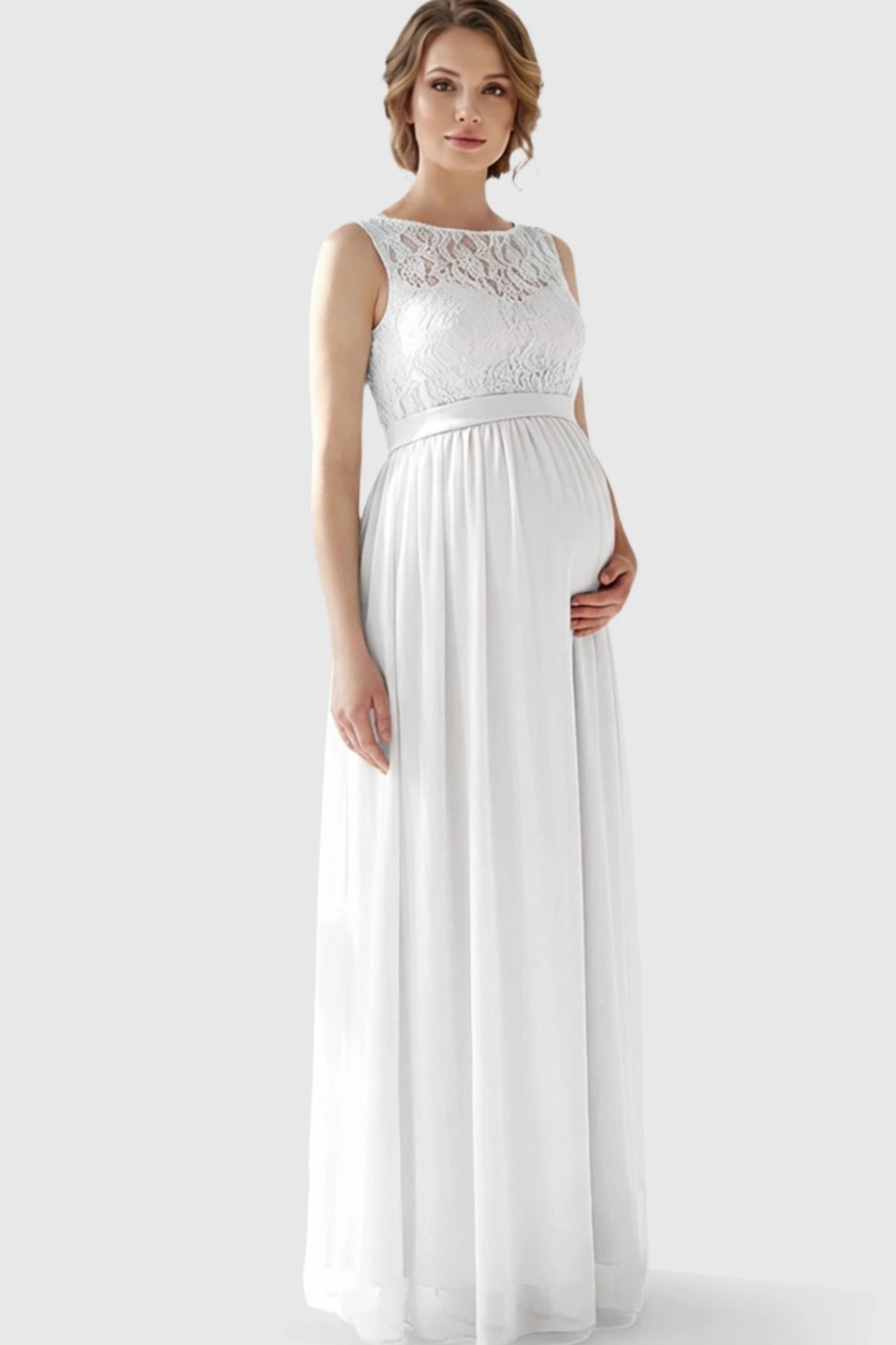 Floral Lace Sleeveless Maternity Maxi Dress Floral Lace Sleeveless Maternity Maxi Dress in White featuring a flowing skirt on a pregnant model.