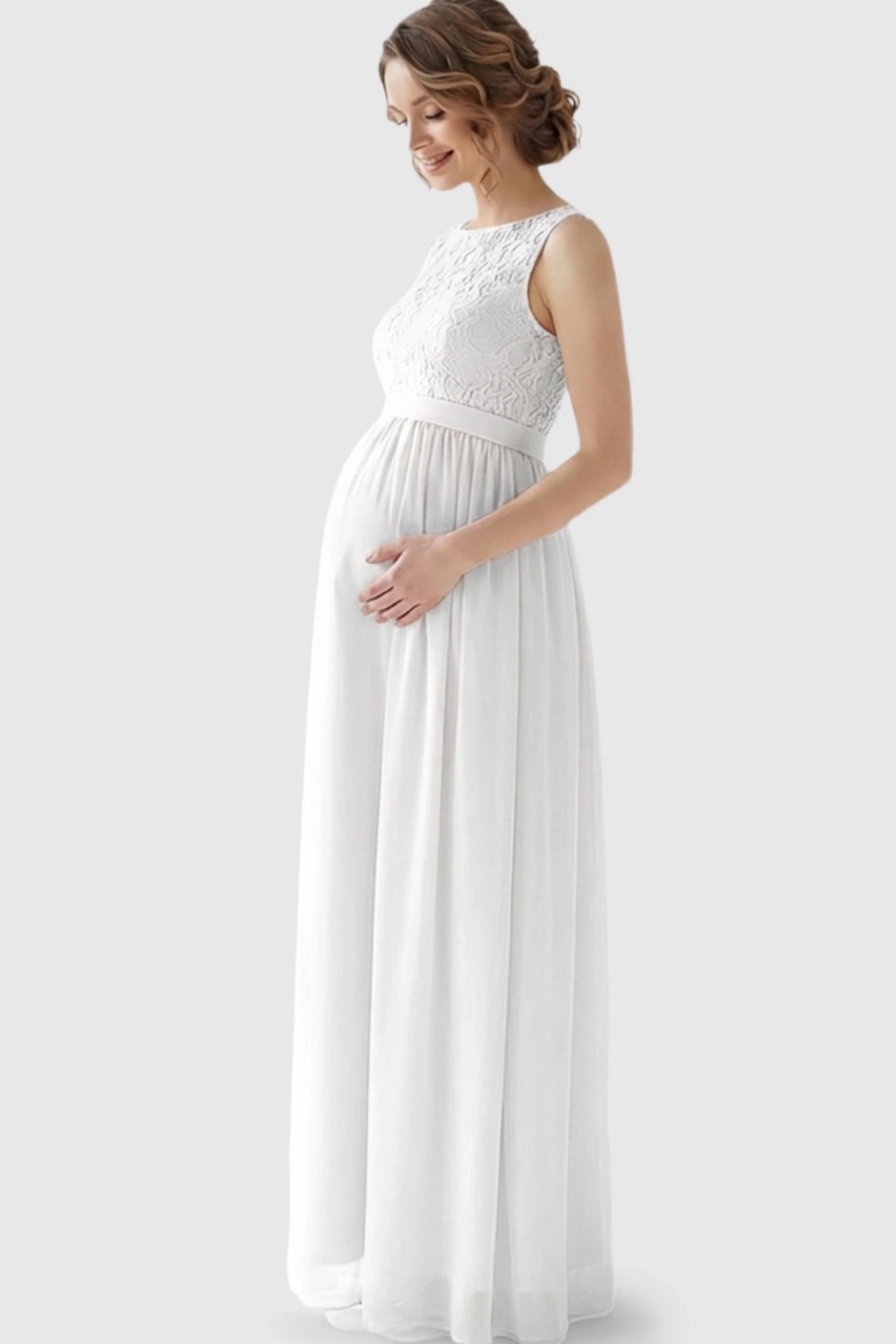 Floral Lace Sleeveless Maternity Maxi Dress Floral Lace Sleeveless Maternity Maxi Dress in White featuring a flowing skirt on a pregnant model.