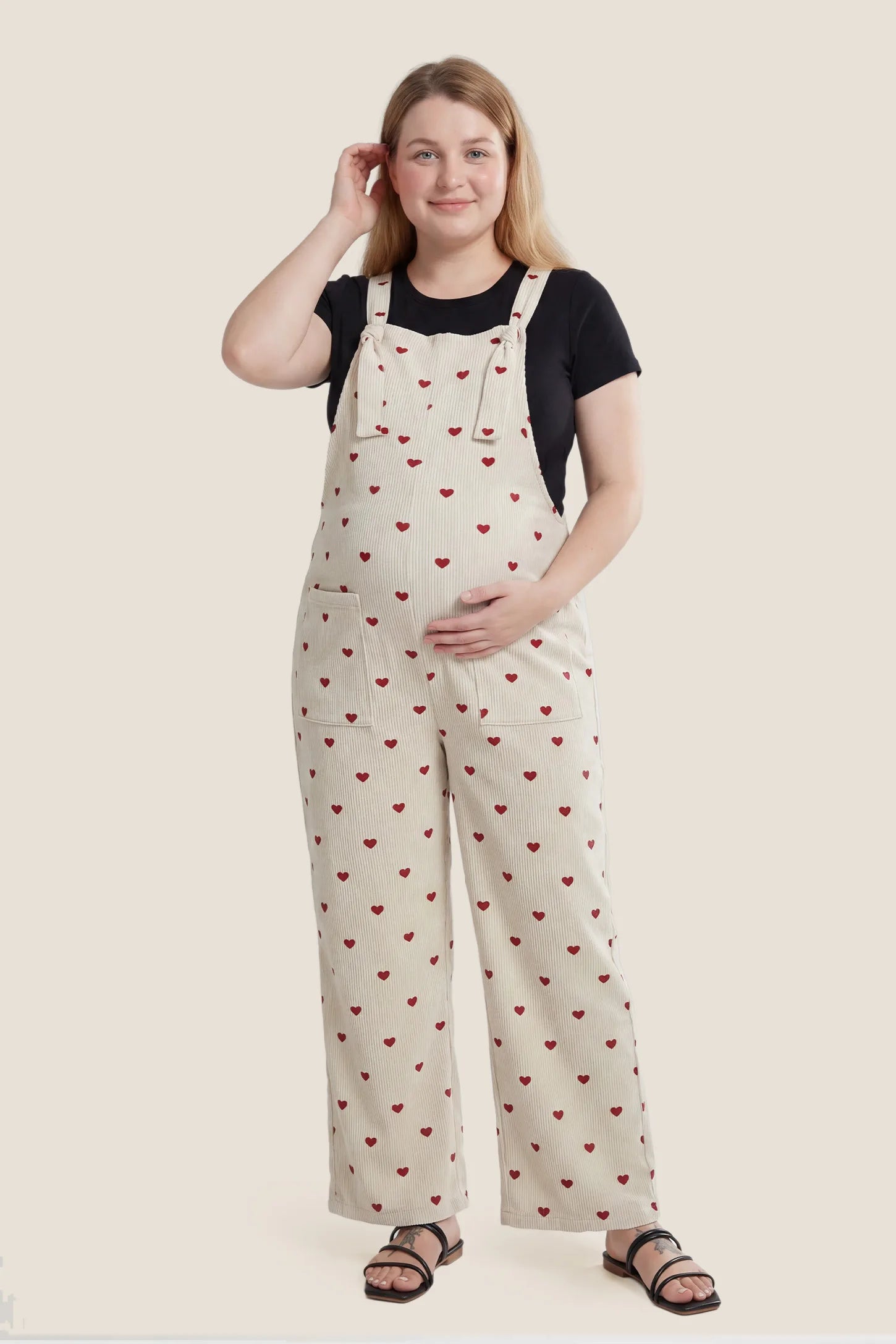 Pocketed Adjustable Maternity Overalls Plus size pregnant model wearing Pocketed Adjustable Maternity Overalls in Oat Cherry Heart.